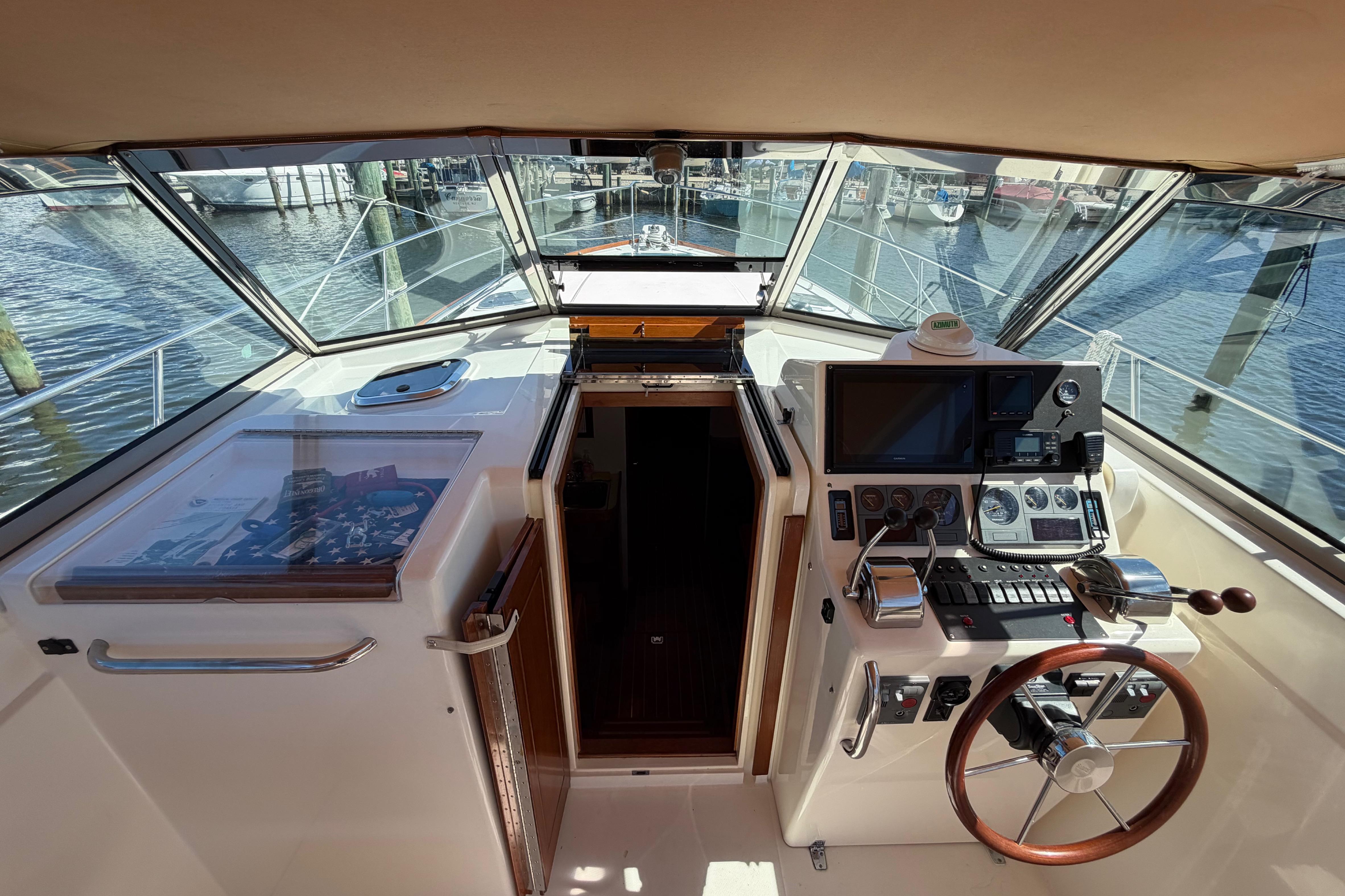Cockpit view of 2000 Sabreline 36 Express boat with steering wheel and navigation controls.