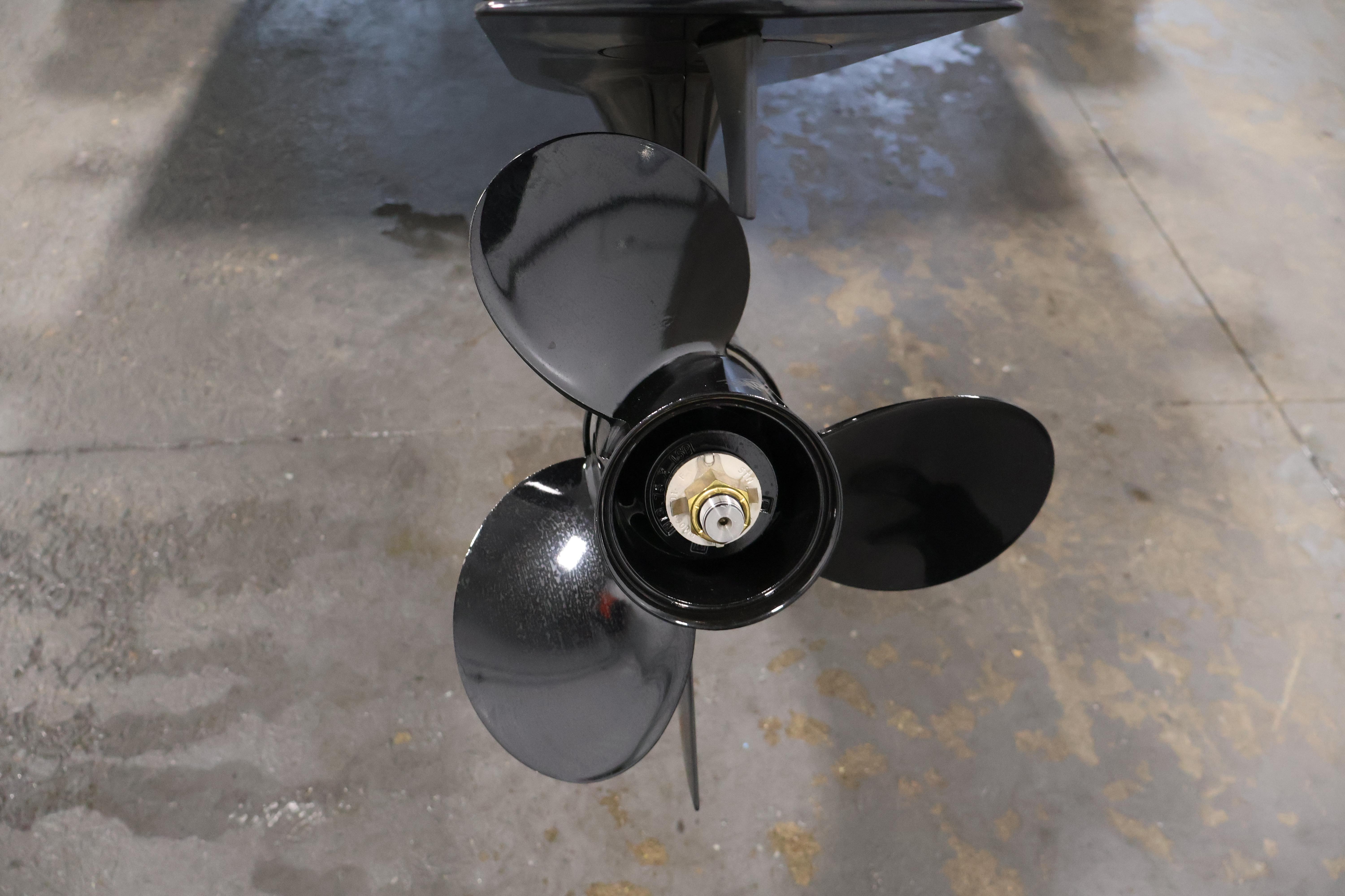 Close-up of a 2026 Bayliner Trophy T18 boat propeller on a concrete floor.