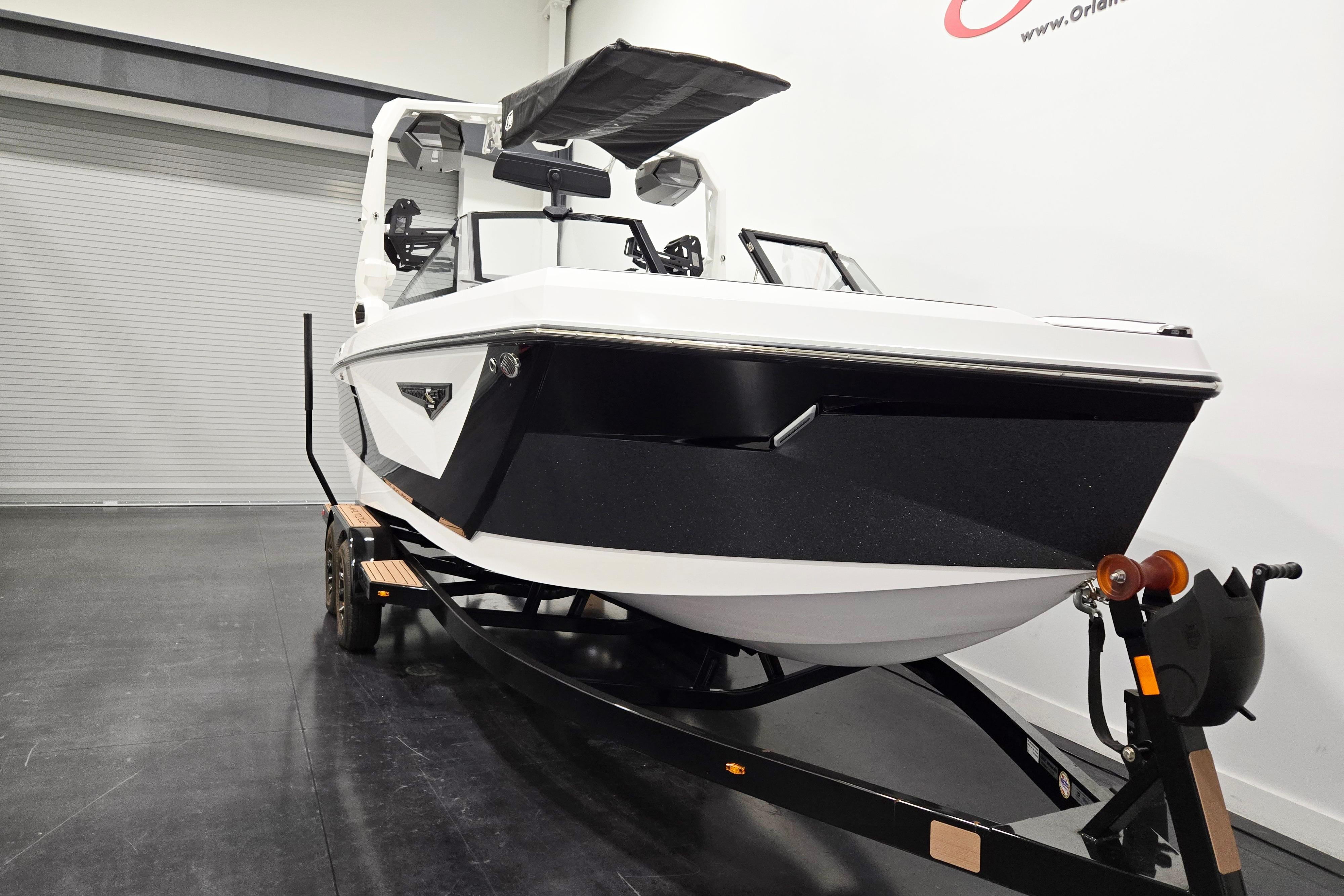 2026 Nautique Super Air Nautique S23 boat on trailer in showroom.