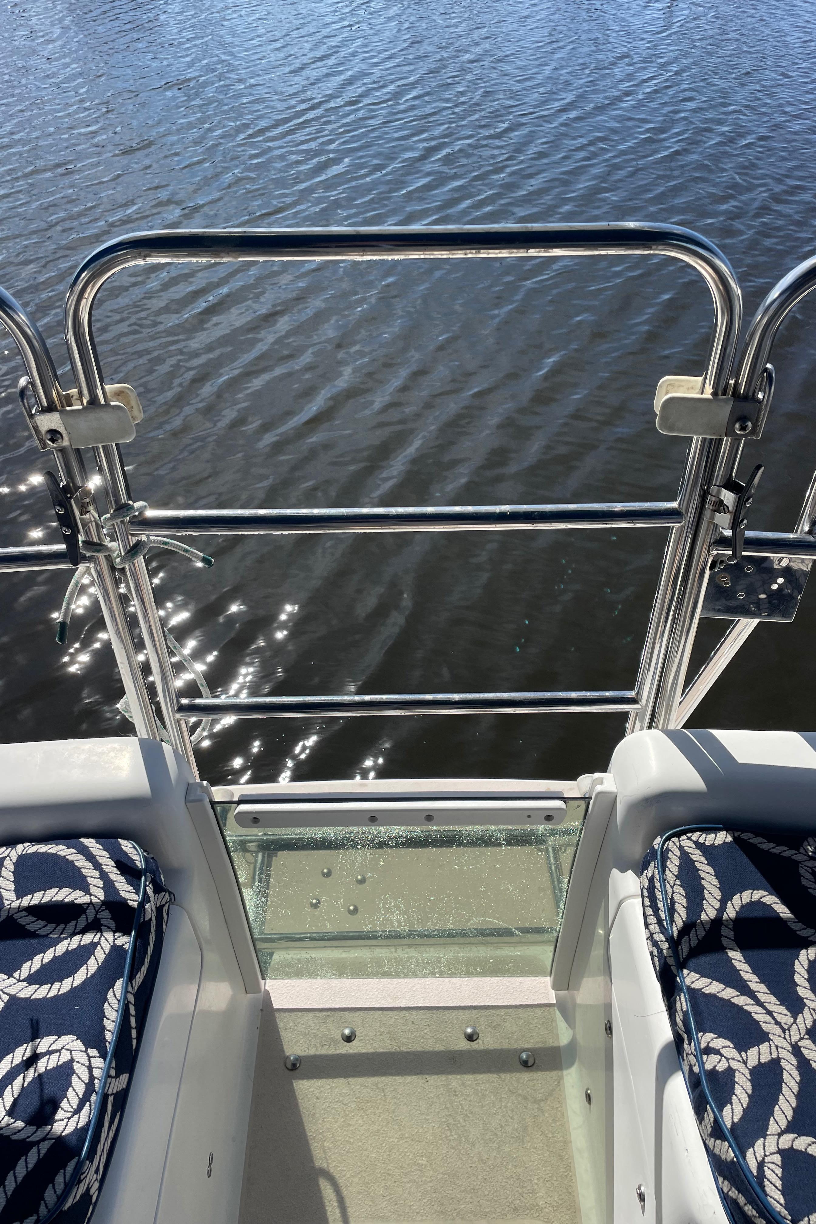 Catalina 400 sailboat deck view with nautical-themed seating, overlooking water.