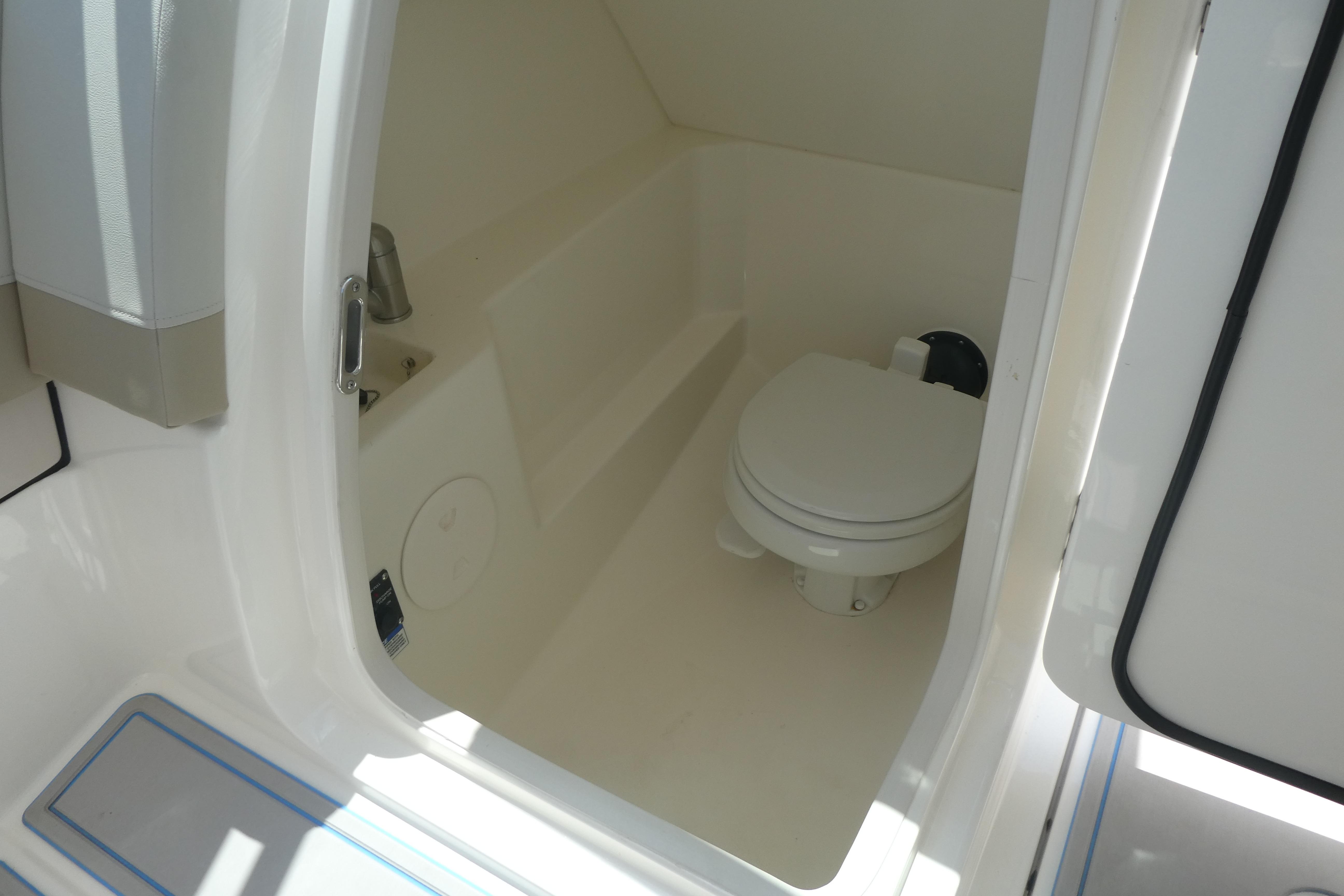 Interior view of 2022 Boston Whaler 240 Vantage boat bathroom.