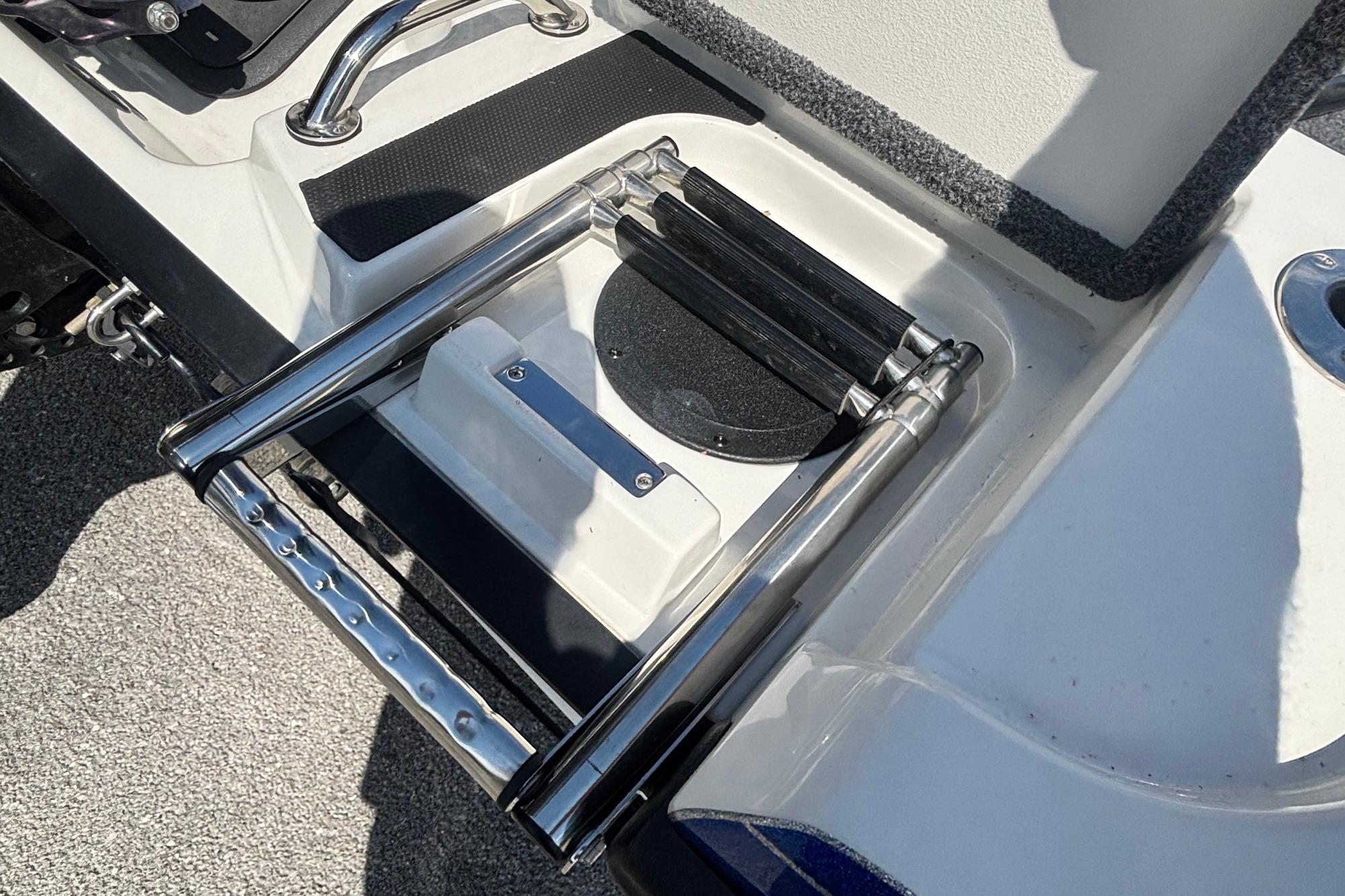 Foldable ladder on a 2022 Ranger 1880MS boat deck, featuring stainless steel construction.
