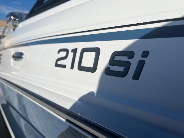 Close-up of 2024 Tahoe 210 Si boat model name on white hull.