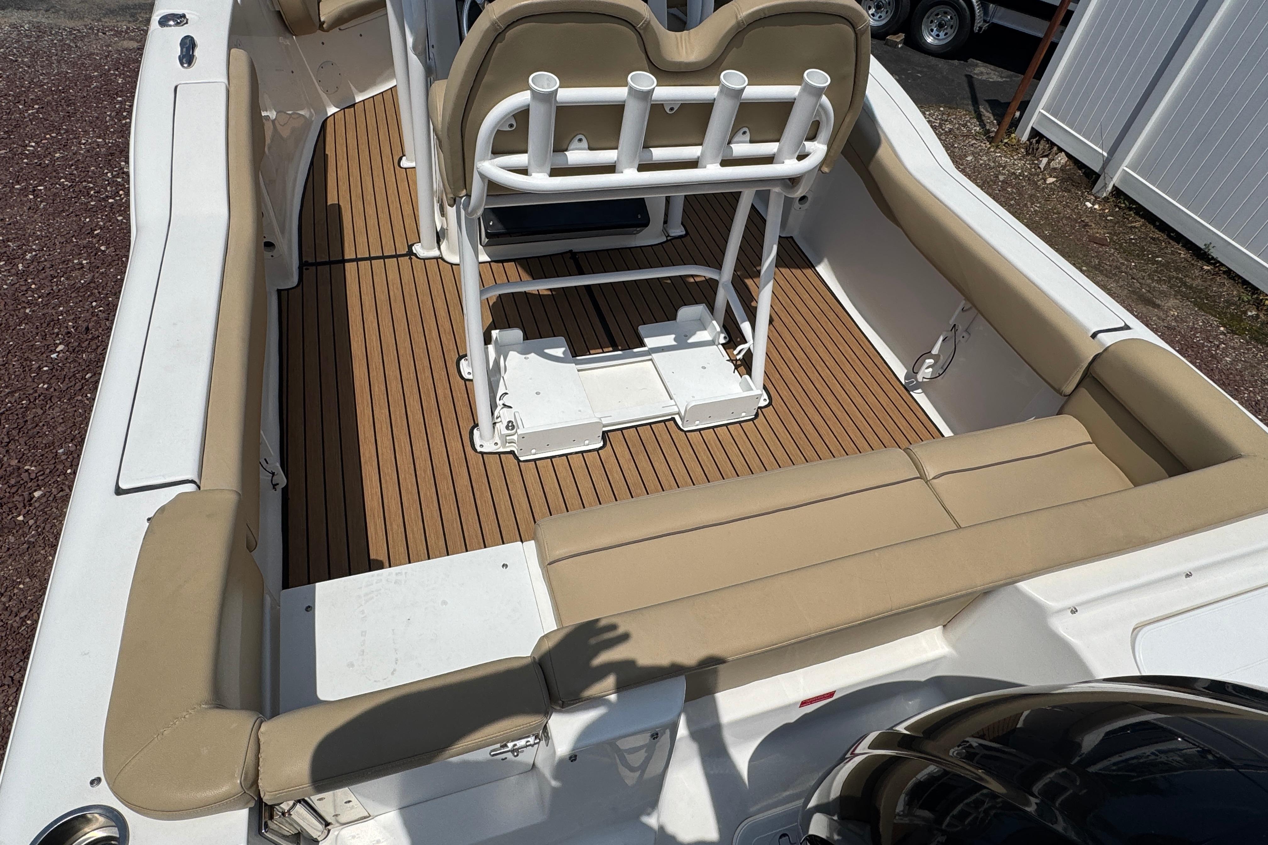 2016 Tidewater 230 LXF boat interior with tan seating and wood-style flooring.