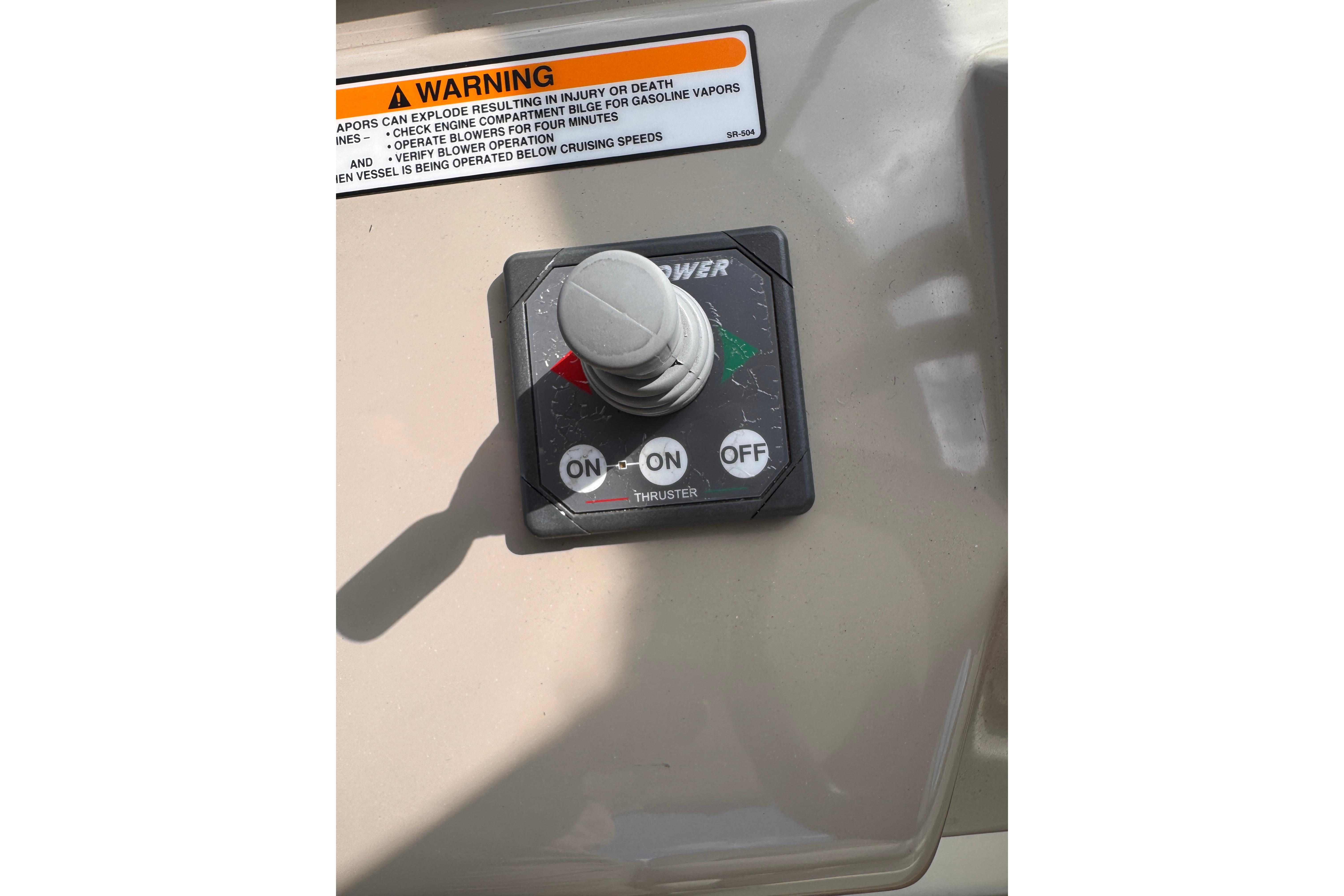 Control panel of a 2008 Sea Ray Sundancer 350 boat with warning label.