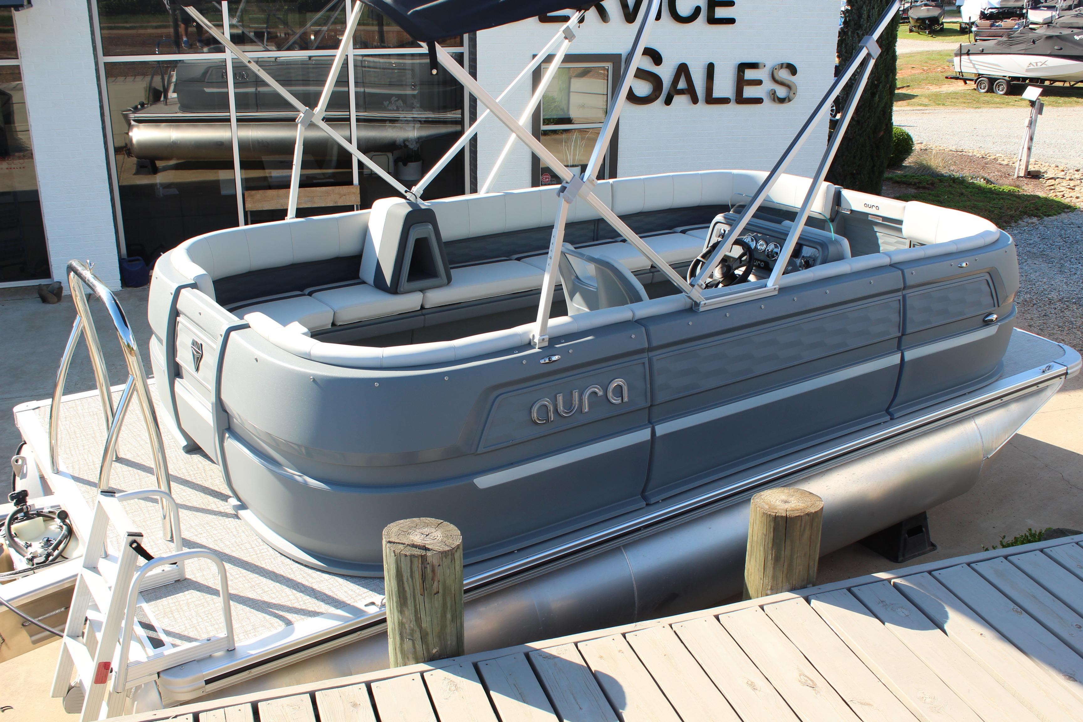 2026 Tahoe Pontoon Aura boat displayed at a sales service location.