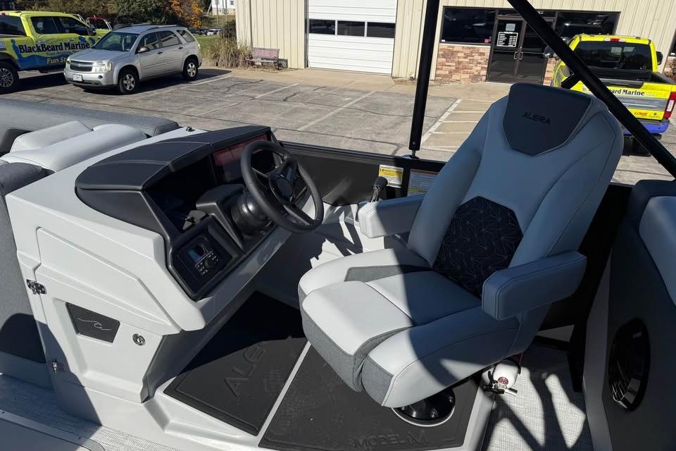 2026 Alera M 25Q boat interior with modern steering and comfortable seating.