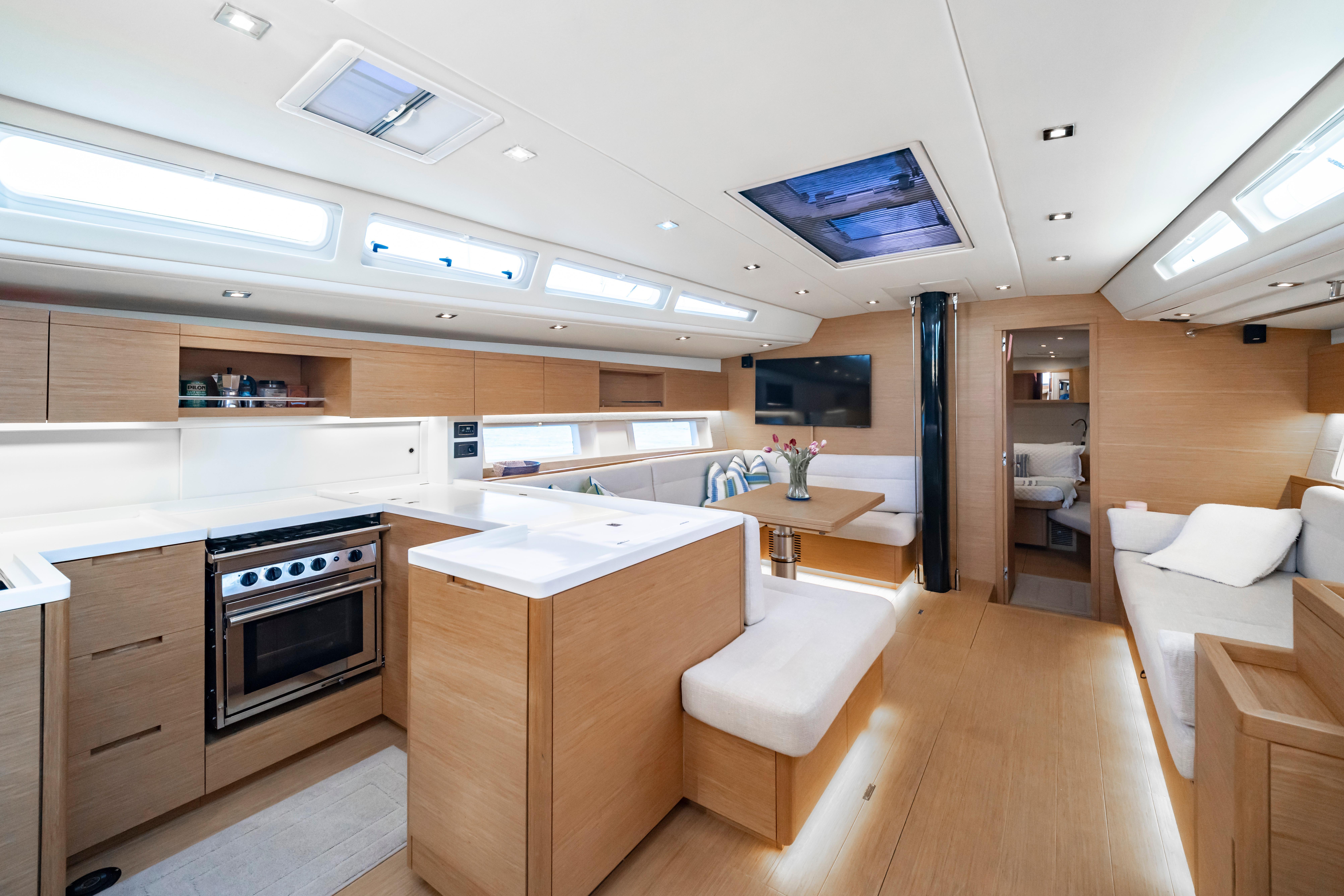 Luxurious interior of 2016 Grand Soleil 58 yacht with modern kitchen and seating area.