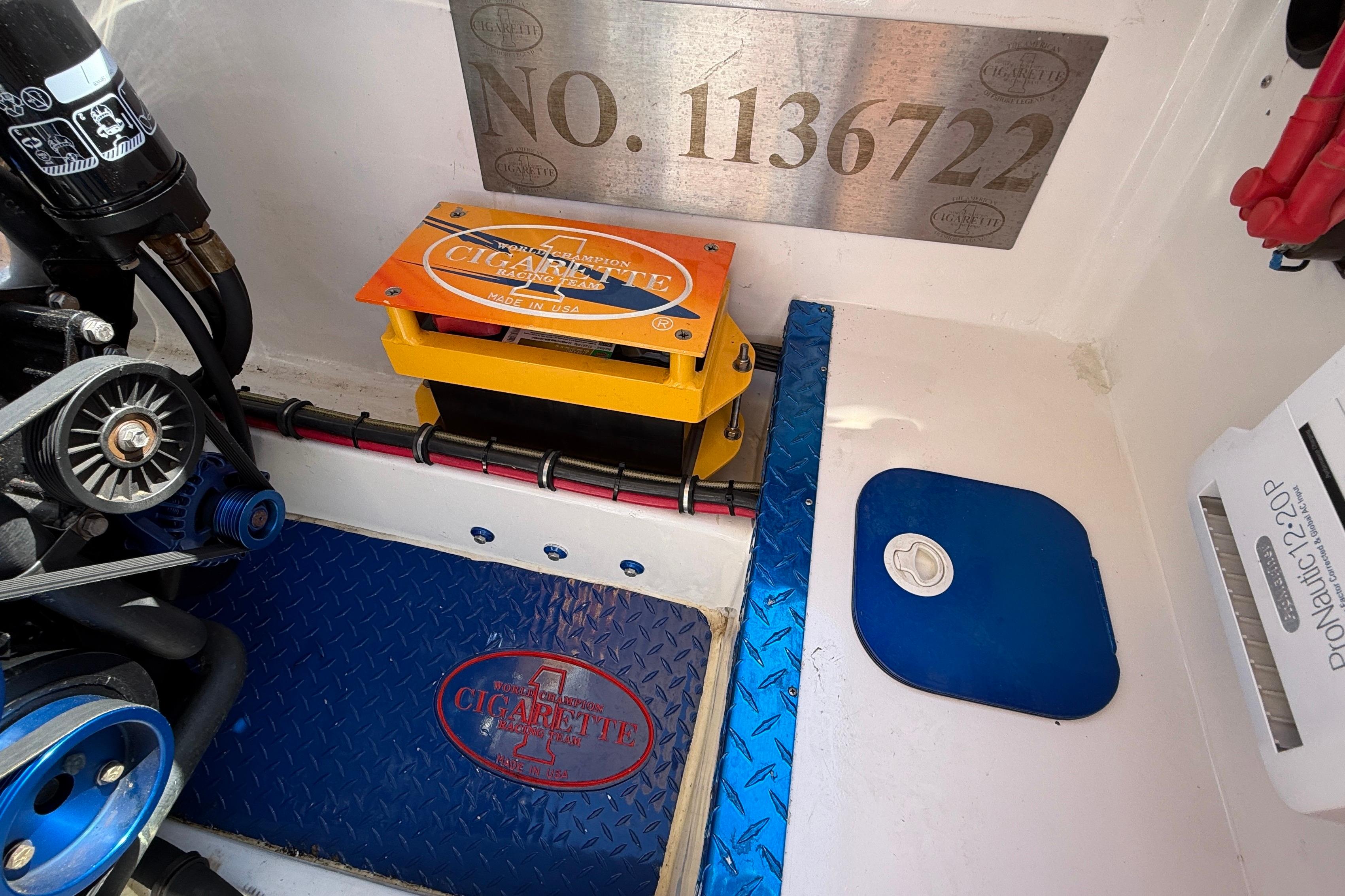 Engine compartment of a 2002 Cigarette 35' Cafe Racer boat, featuring branded components.