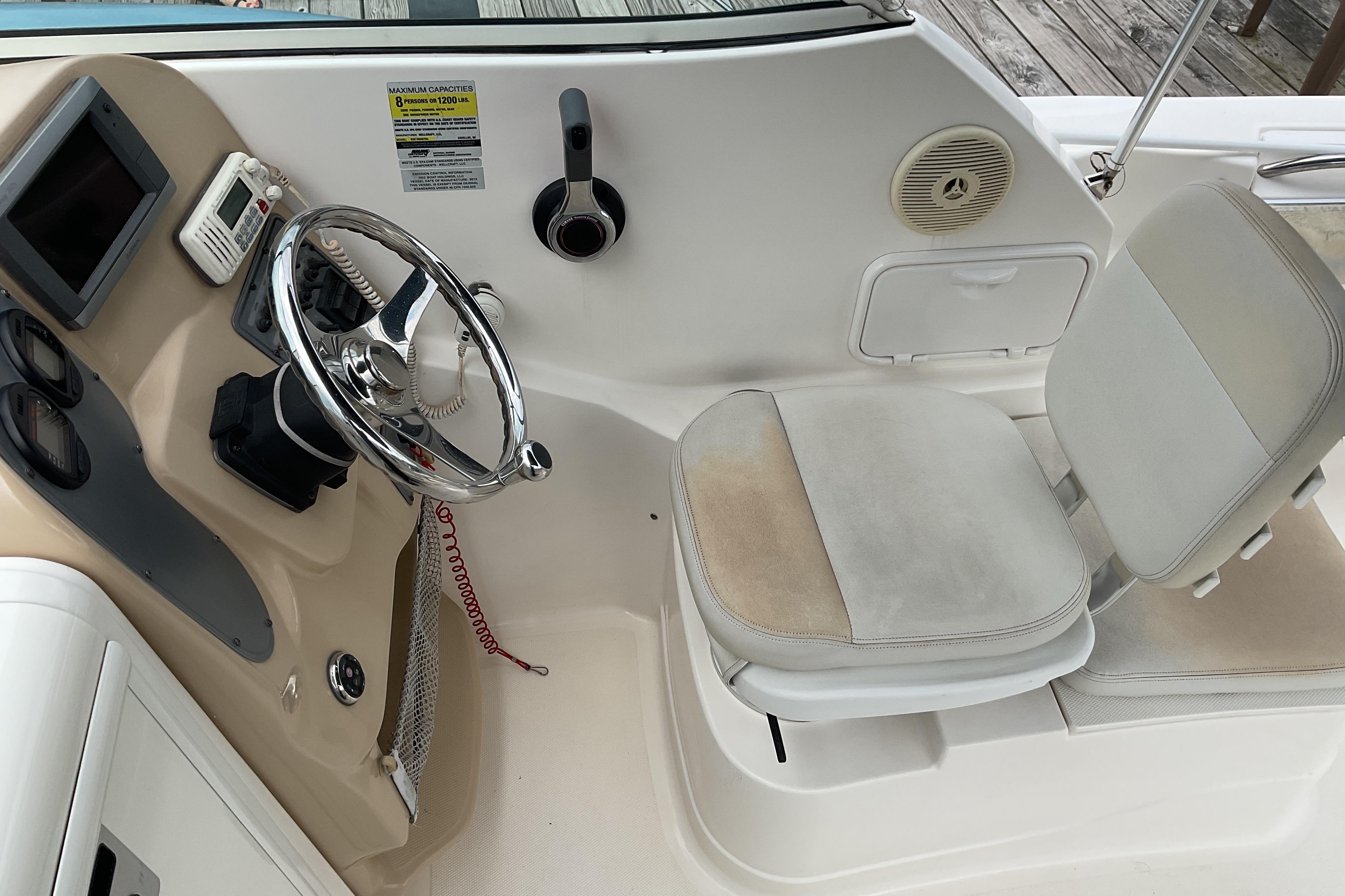 2012 Wellcraft 232 Coastal boat helm with steering wheel and seating area.