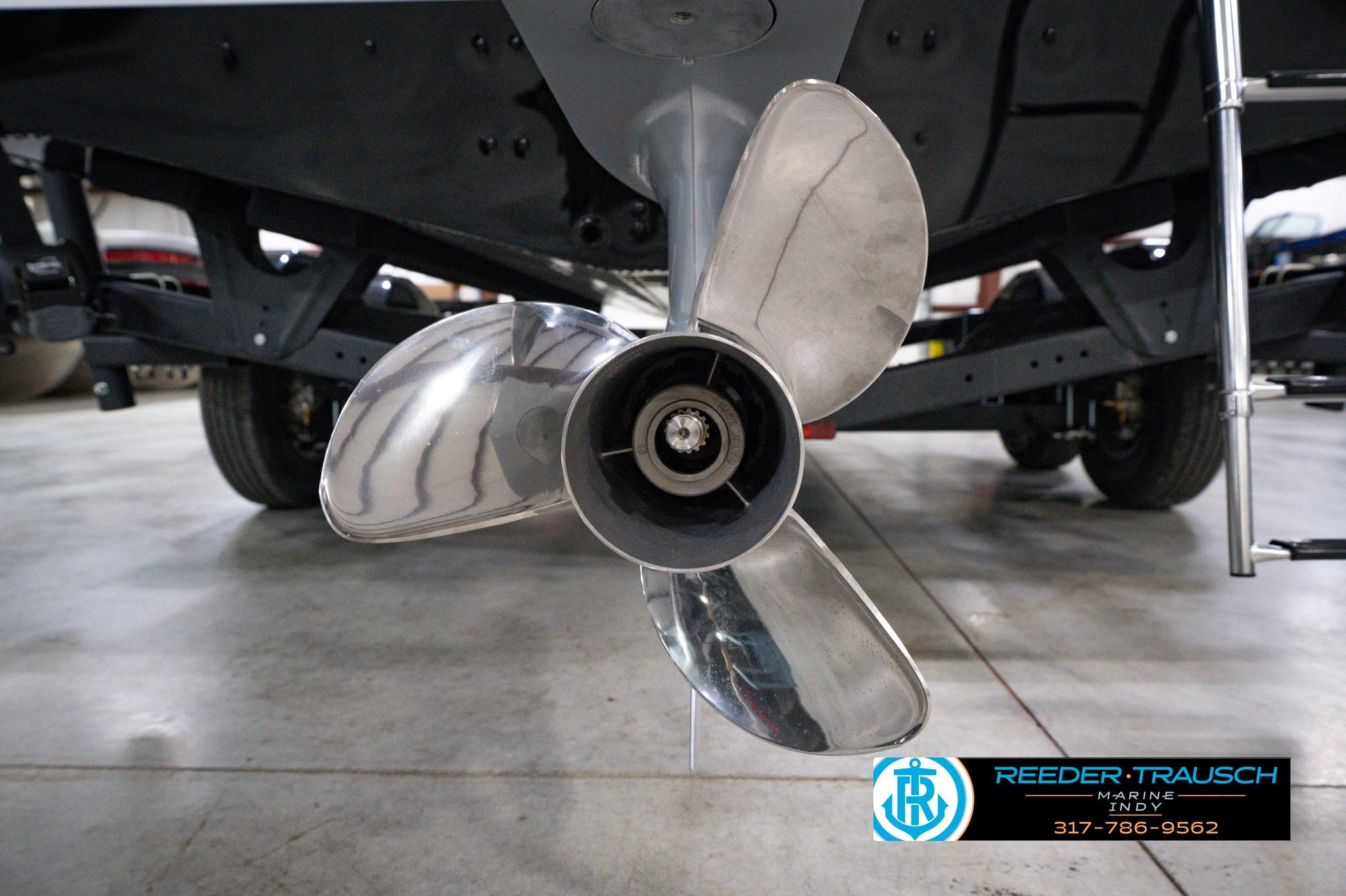 Propeller of 2026 Lund 1875 Impact XS SS boat in a showroom setting.