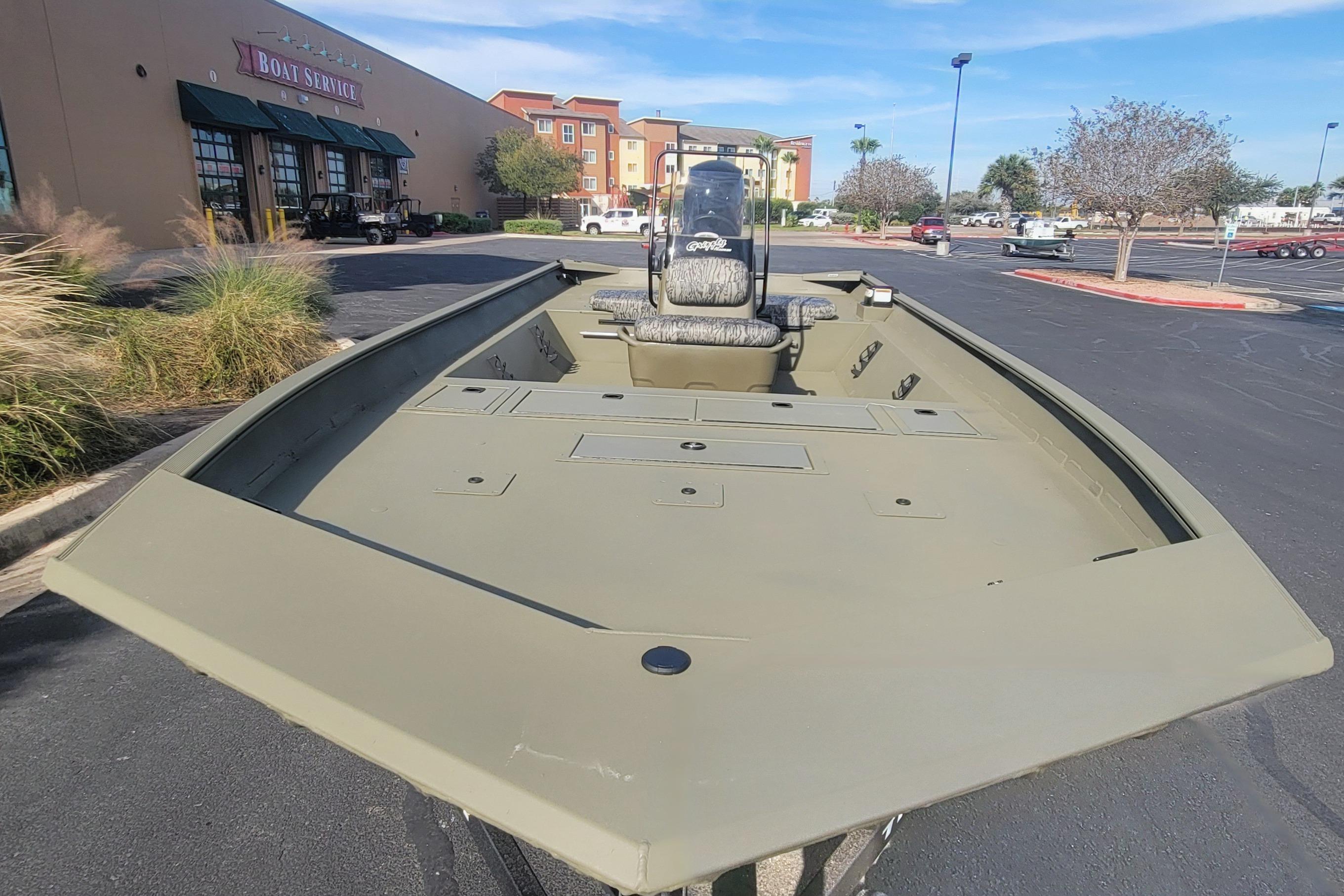 2026 Tracker Grizzly 2072 CC boat in parking lot, near boat service center.