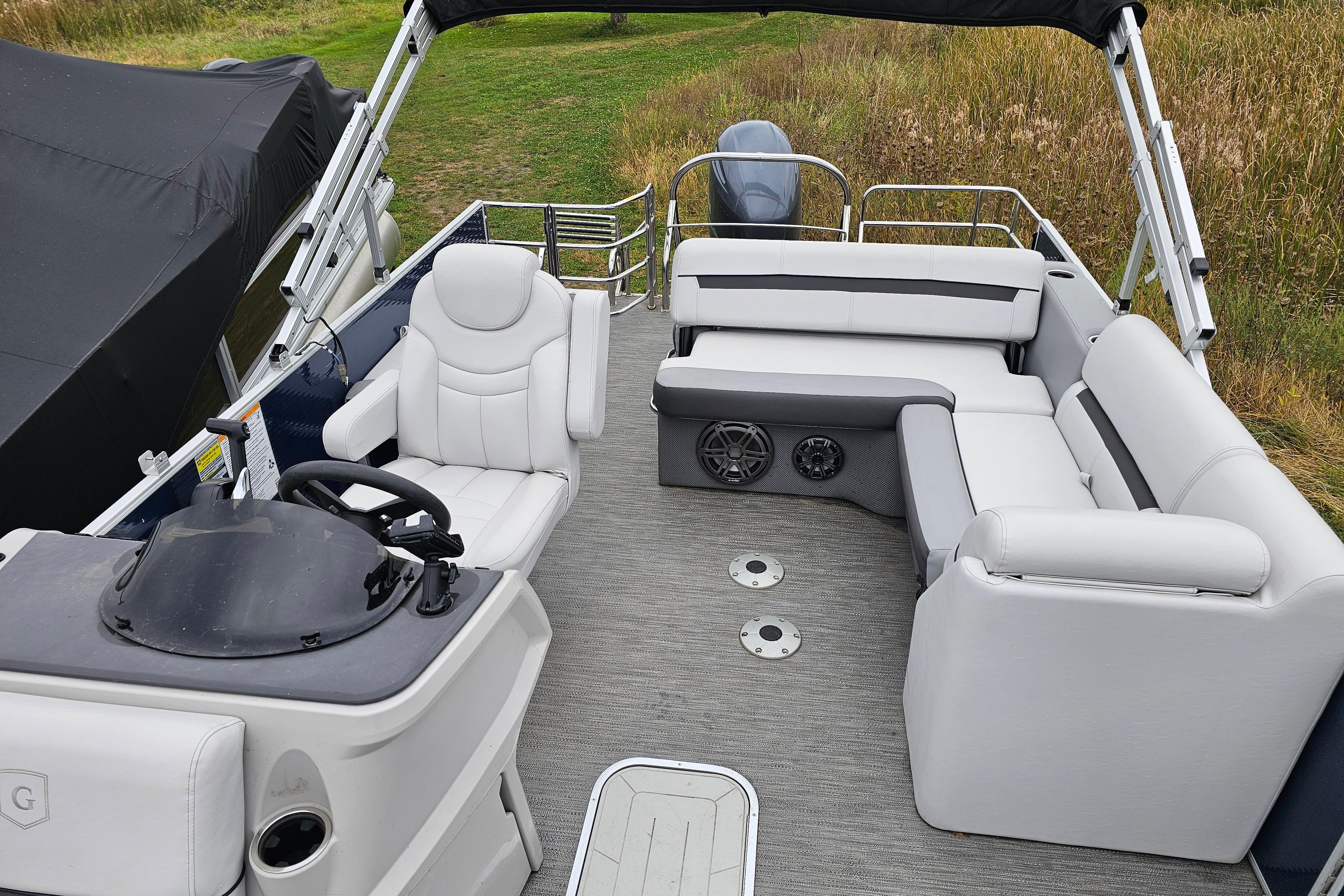 2022 Sweetwater 2286 SFL pontoon boat interior with plush seating and steering console.