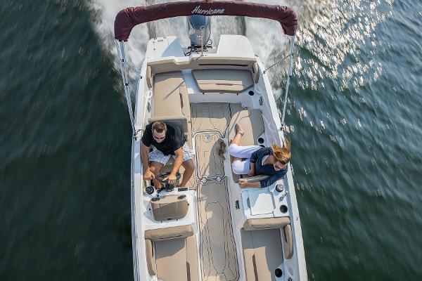 2025 Hurricane SunDeck Sport 205 OB boat cruising on water, aerial view.