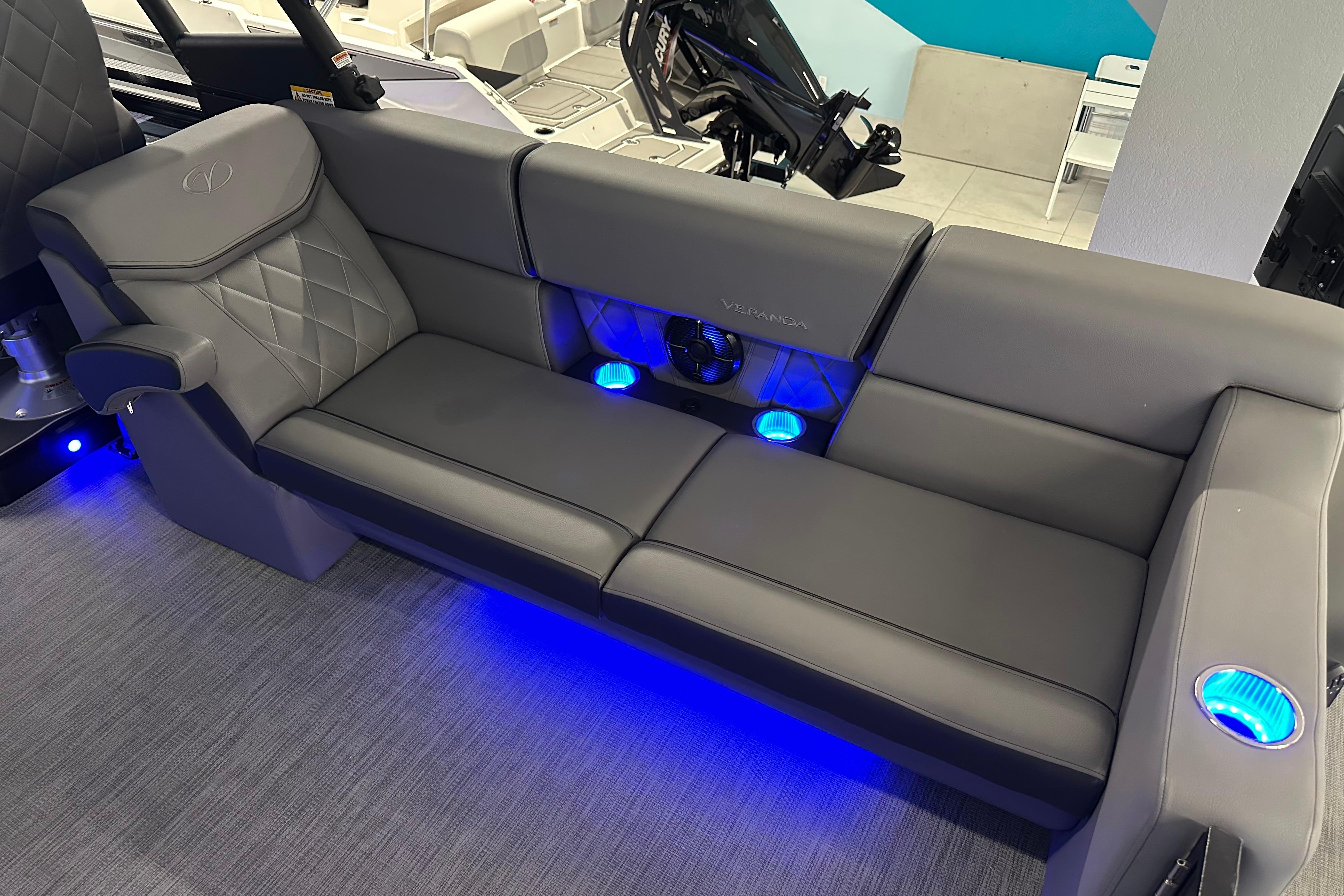 Luxurious seating on 2025 Veranda VX 27 DCRC boat with blue LED lighting.