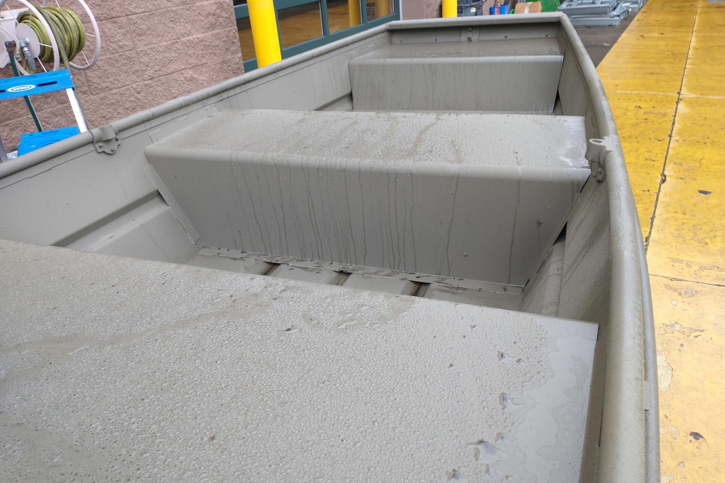 2026 Tracker Grizzly 10 Jon boat interior with wet surfaces, showcasing sturdy construction.