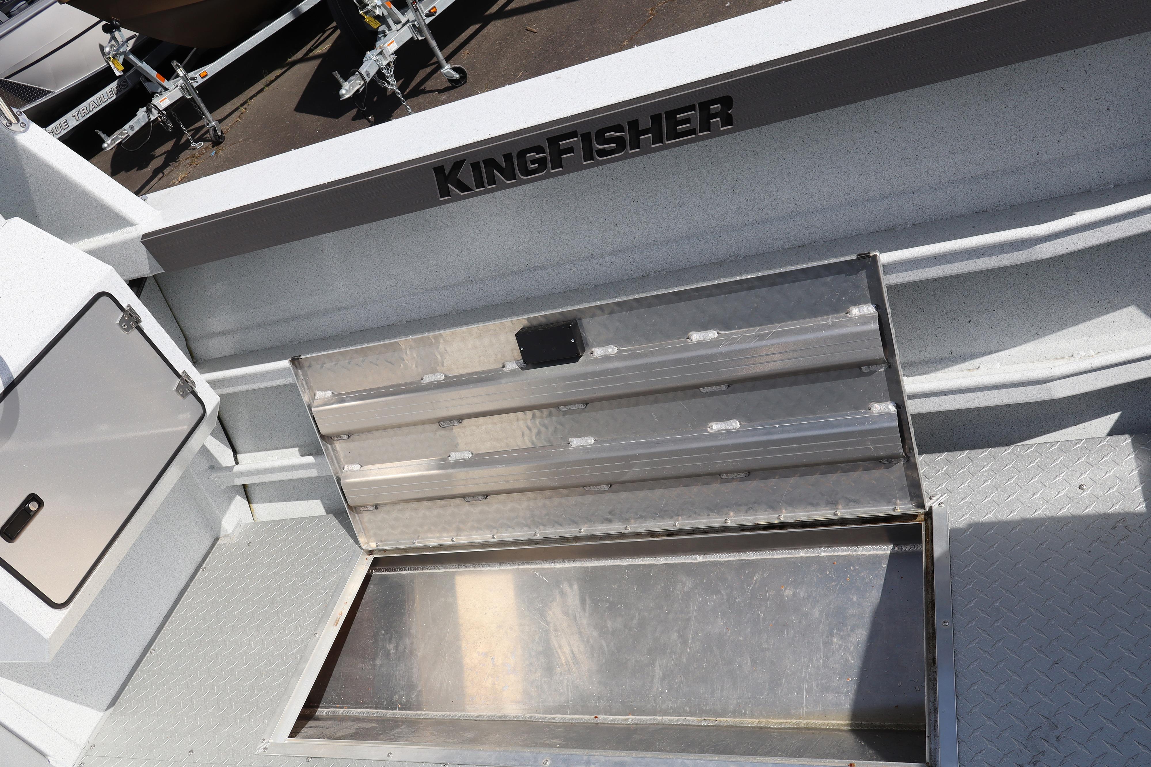 Interior view of 2026 KingFisher 2425 Escape HT boat with storage compartment open.
