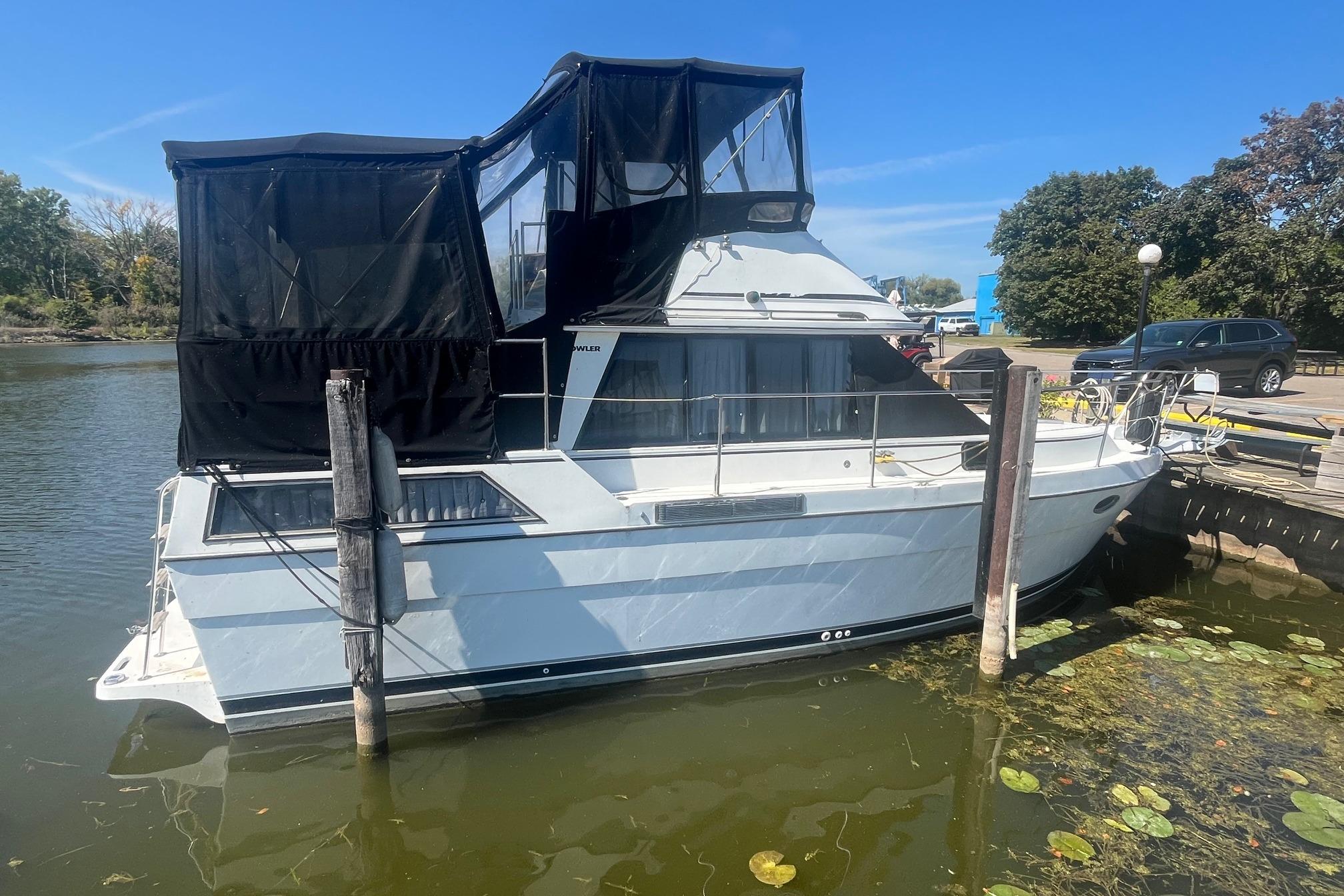1990 Cooper Prowler 35 boat docked in a serene marina setting.