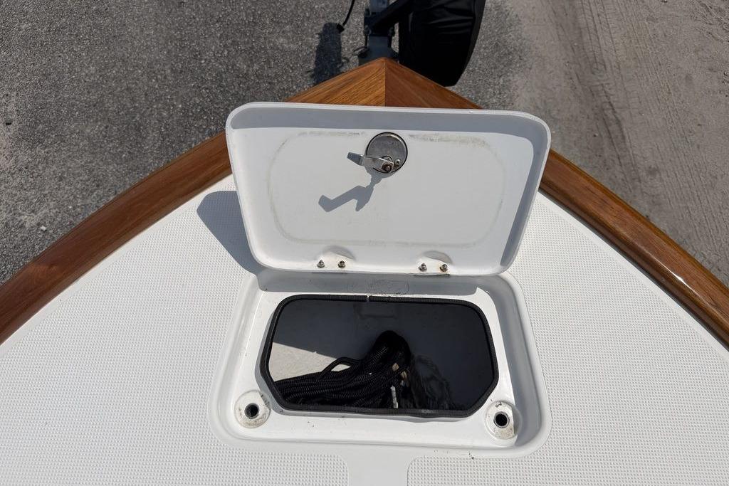 Open storage compartment on 2012 Chaos 16 Bonefish boat deck.
