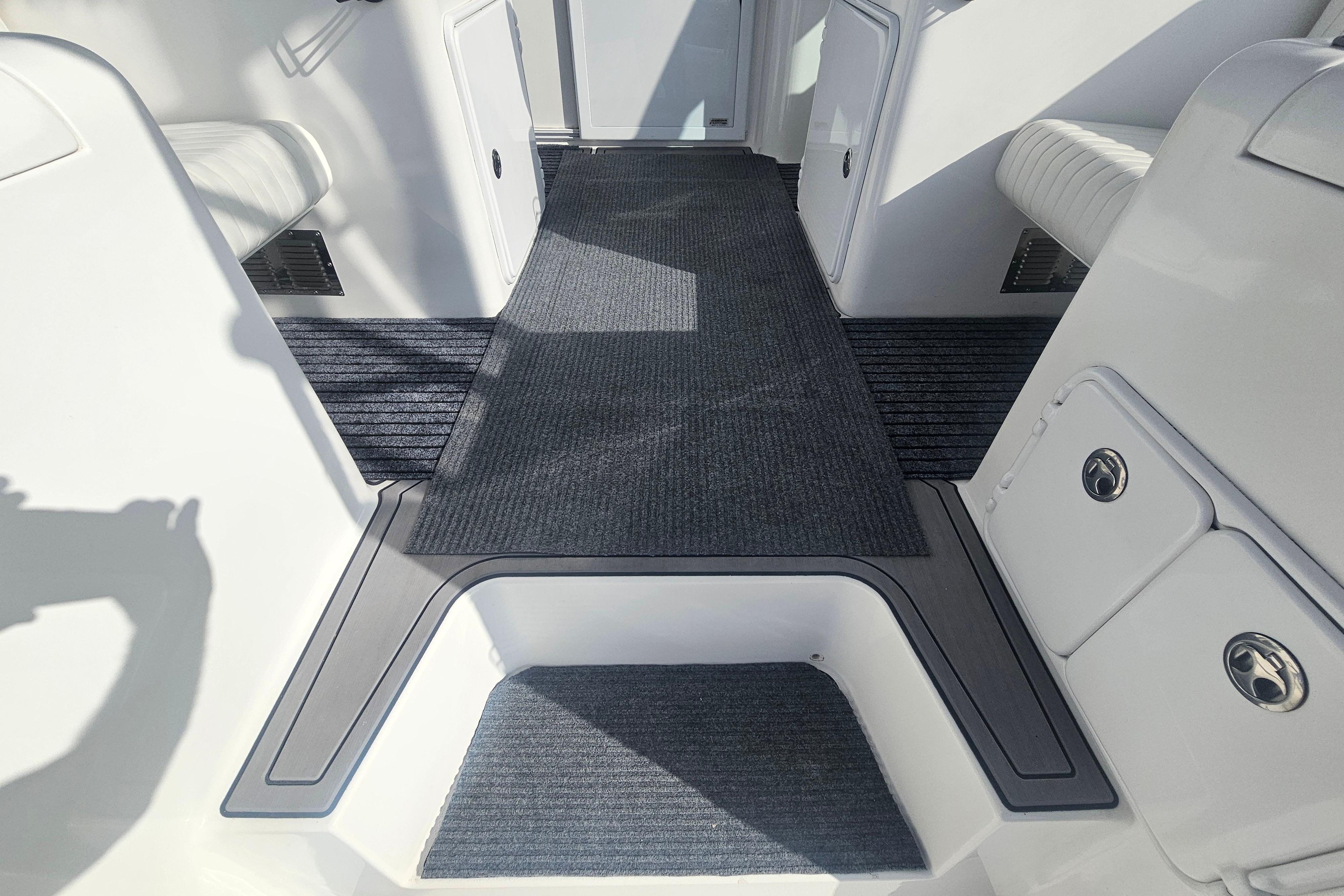Interior view of 2003 Topaz 32 Express boat with carpeted flooring and seating.