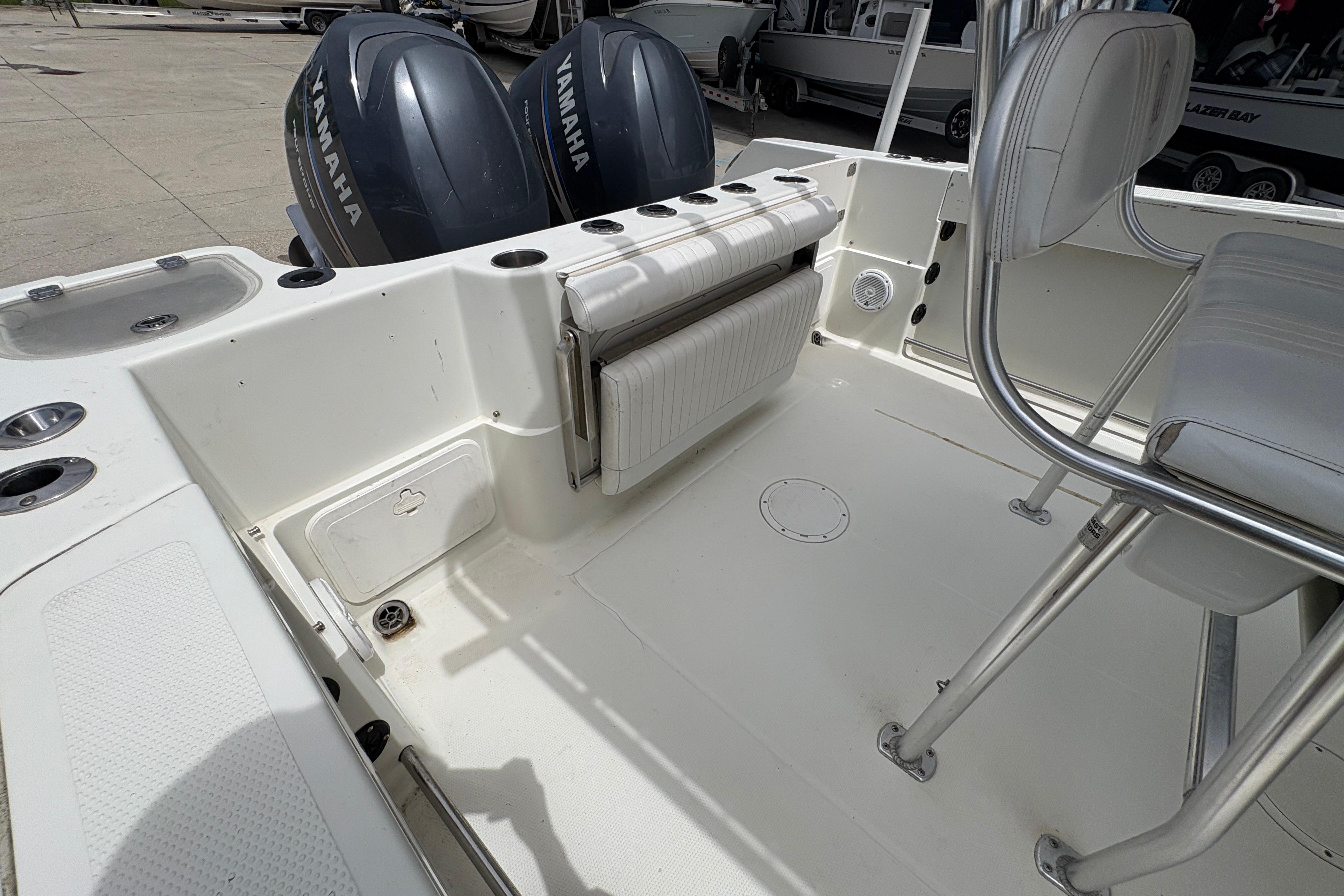2006 Sail Faish 2360 boat interior with Yamaha engines, featuring seating and storage compartments.