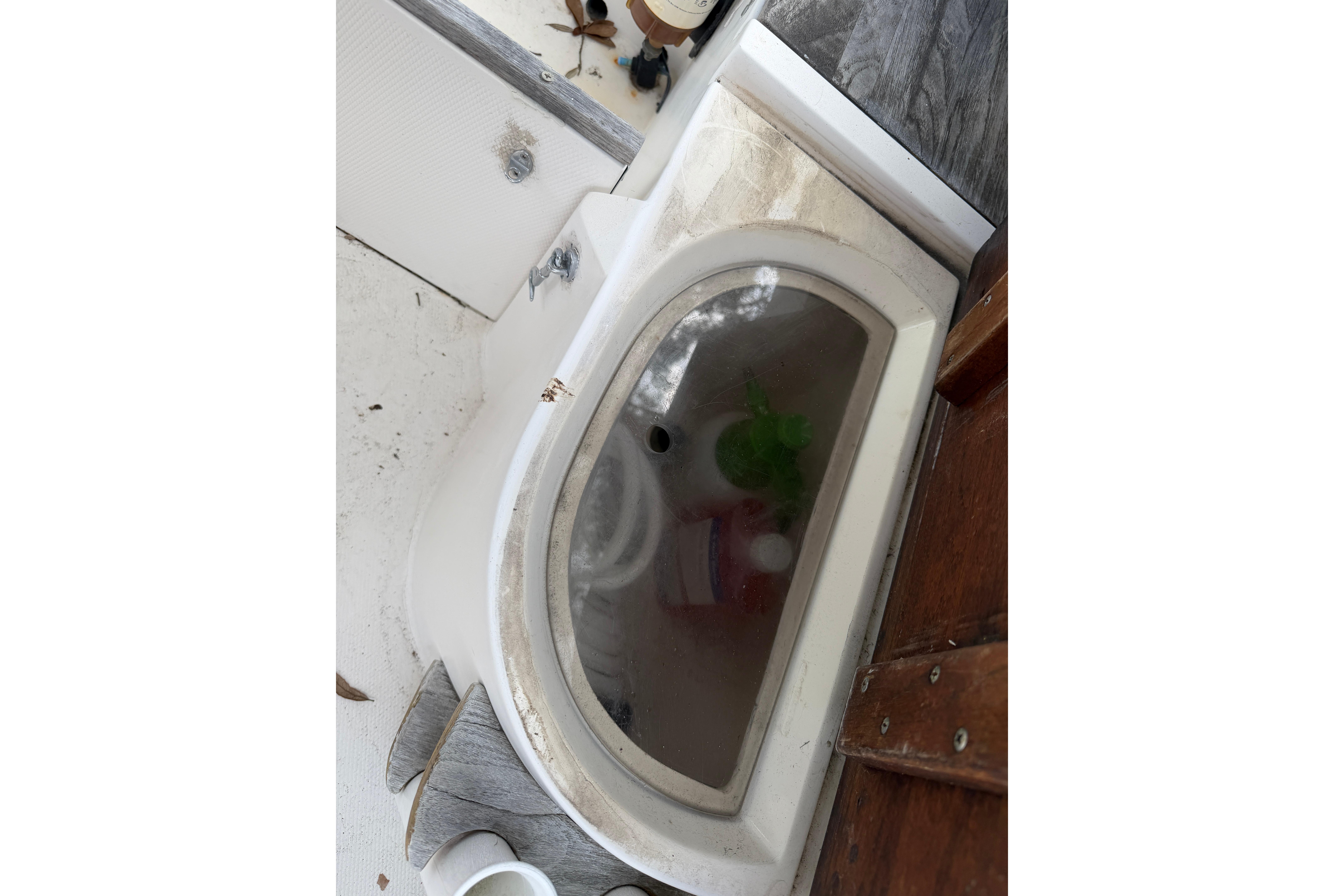 1987 Grady-White Seafarer 226 boat interior with storage compartment and visible items.