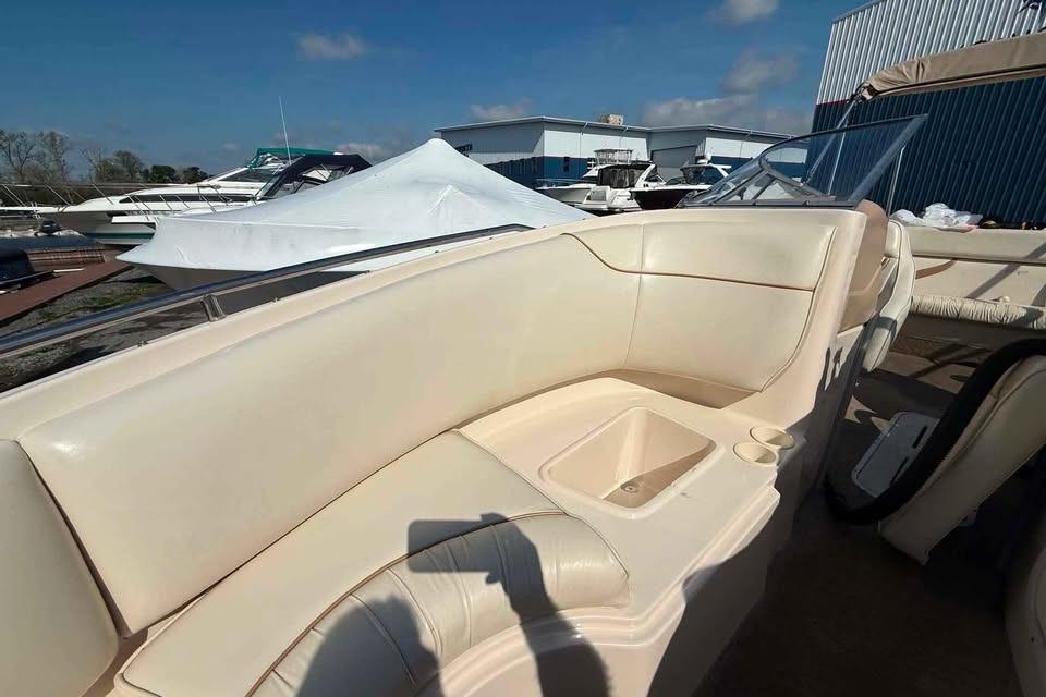 1999 Ebbtide 2300 Bow Rider boat interior with cream seating and cup holders.