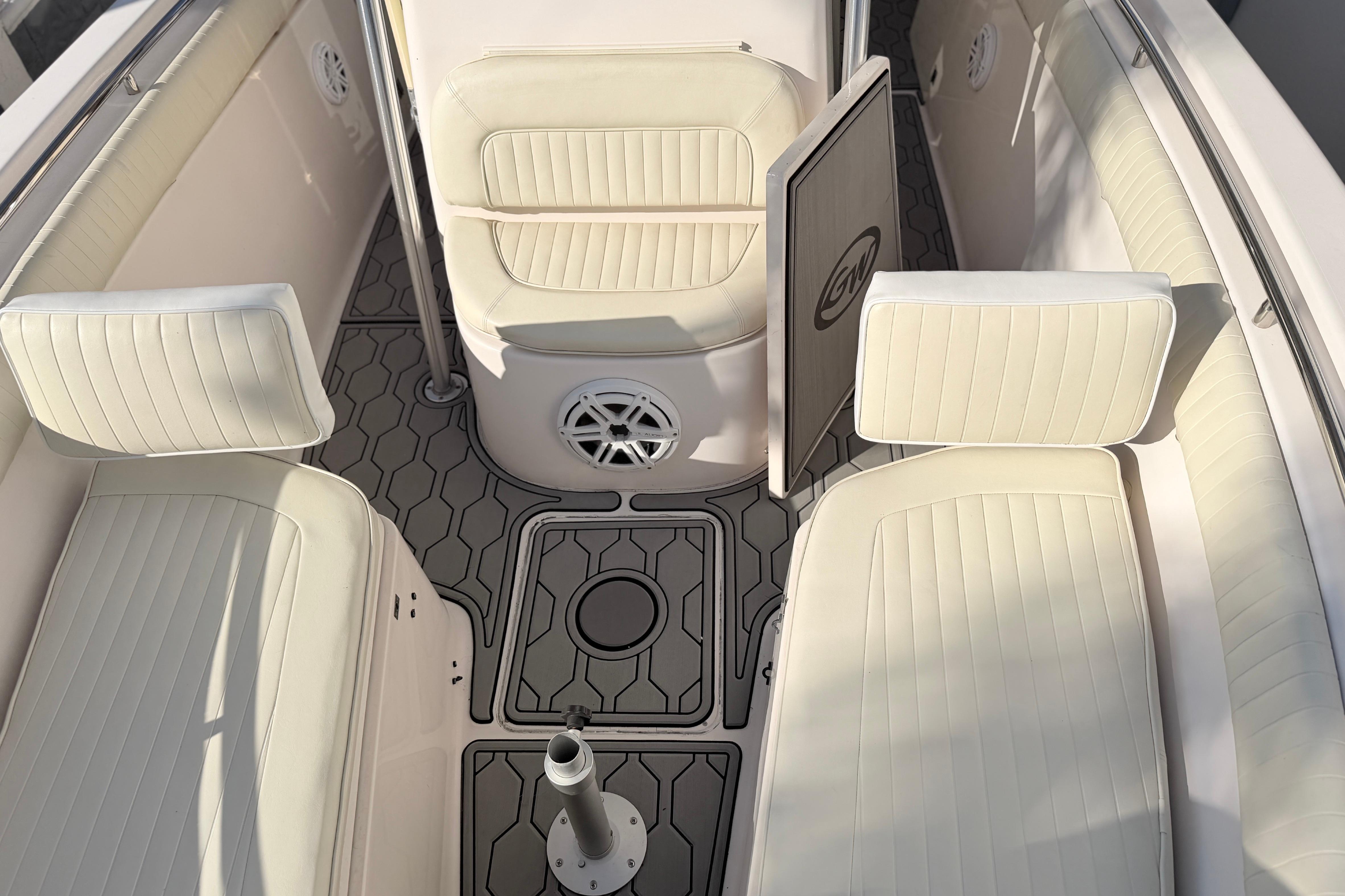 2004 Grady White 273 boat interior with cushioned seating and patterned flooring.