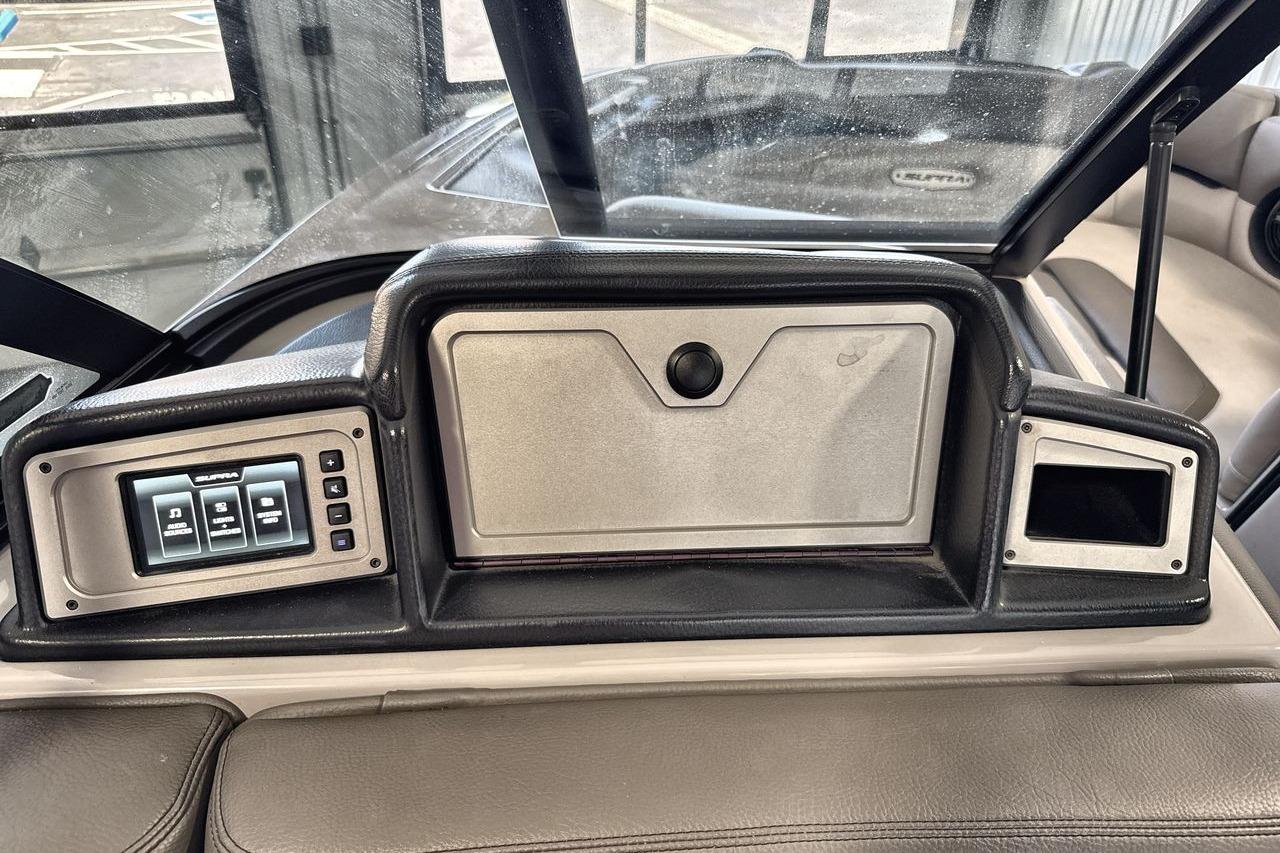 Dashboard of a 2021 Supra SE 550 boat with control panel and storage compartment.