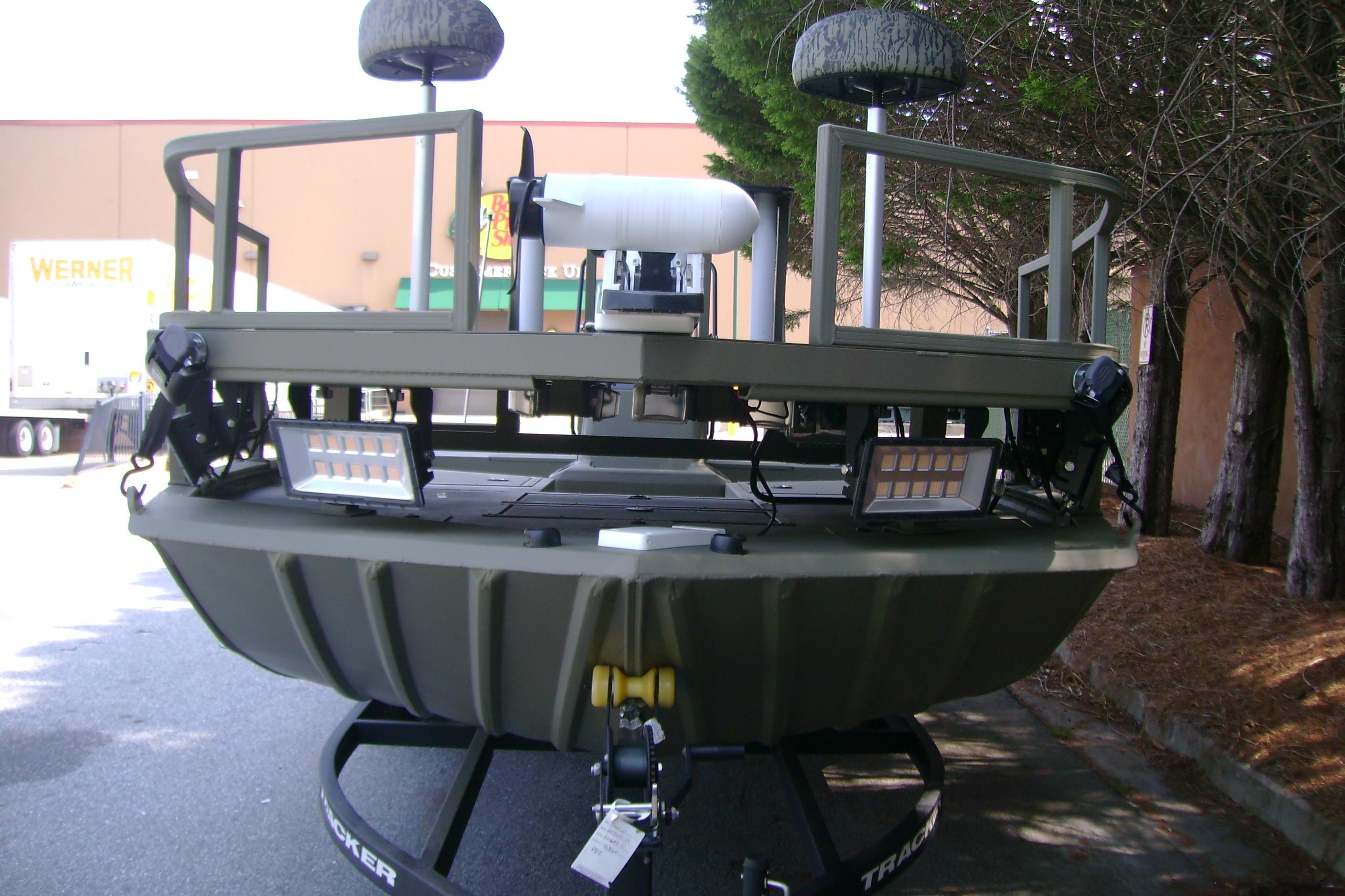 2026 Tracker Grizzly 2072 CC Sportsman boat, rear view with mounted lights and seating.
