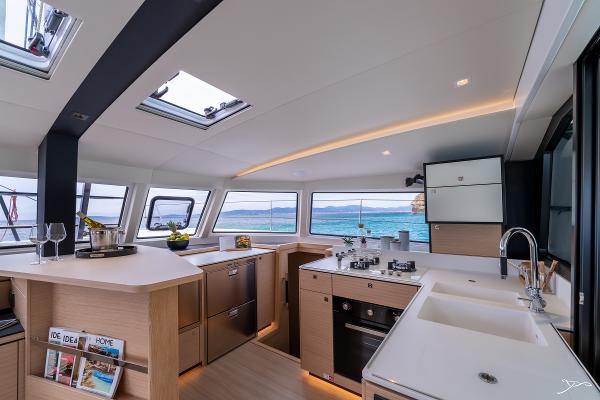 Modern kitchen interior of 2025 Nautitech 44 Open catamaran with ocean view.