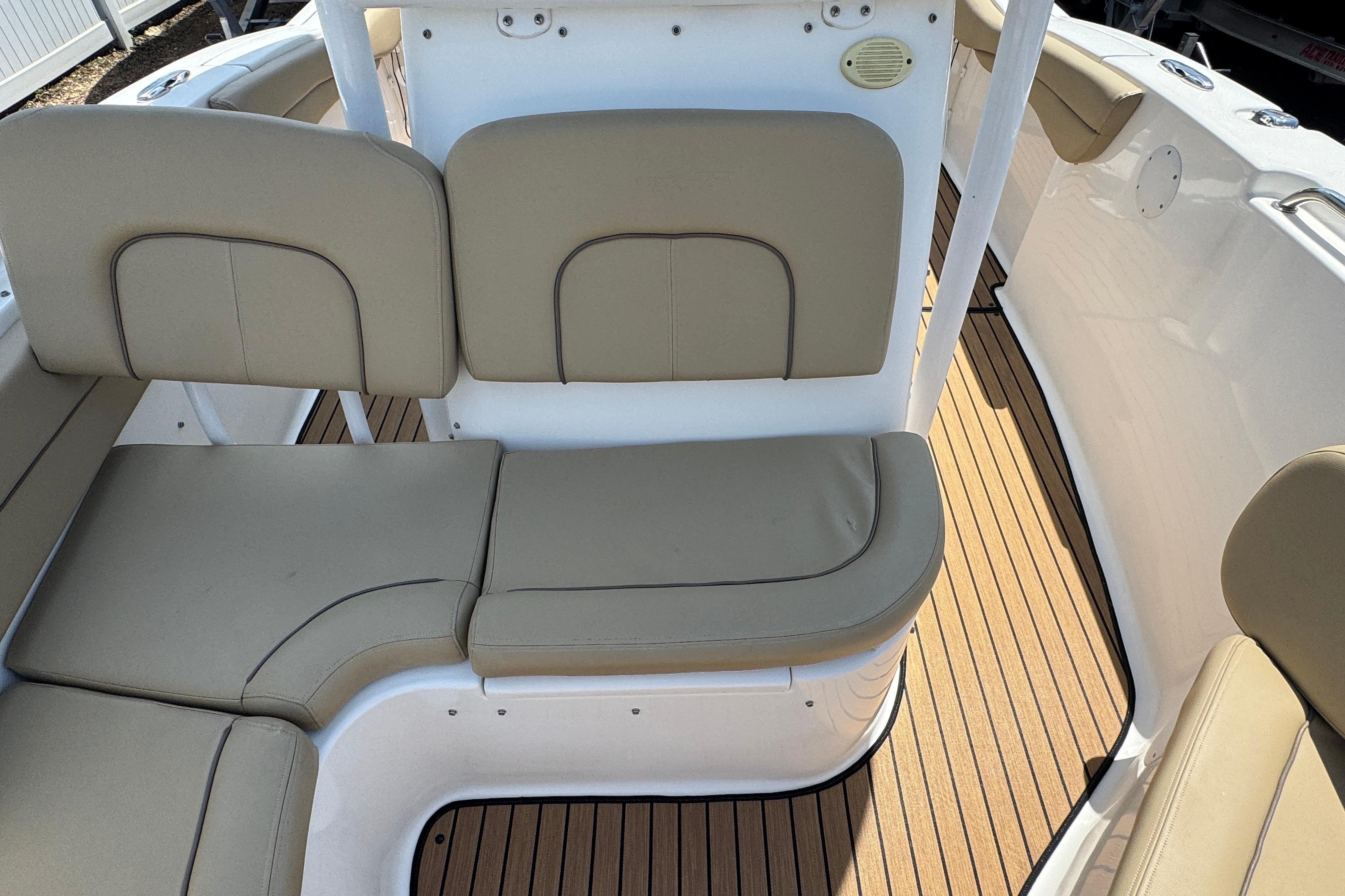 2016 Tidewater 230 LXF boat interior with beige seating and wood-style flooring.