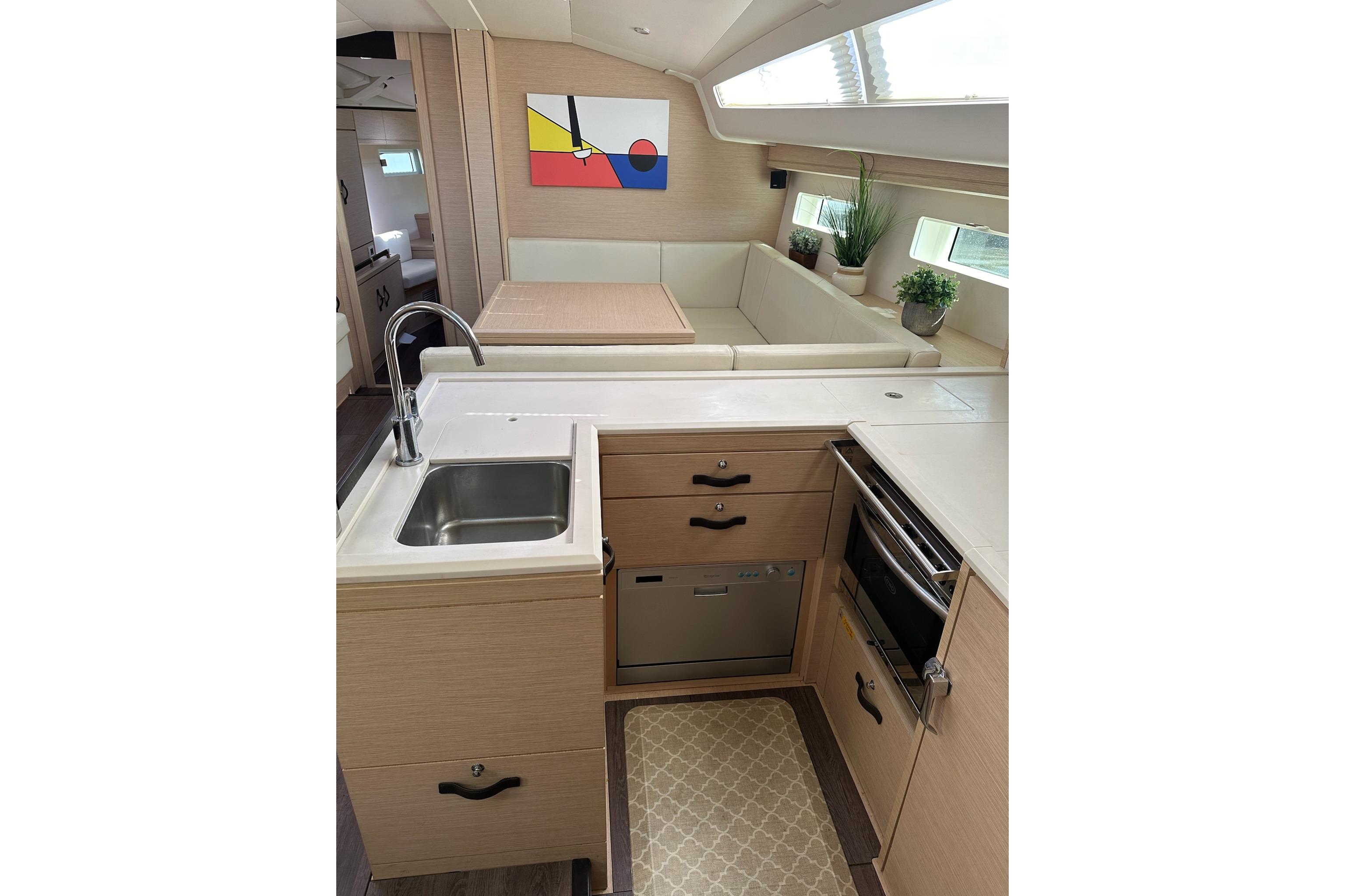 Modern kitchen interior of 2018 Jeanneau 51 yacht with sleek design and natural light.