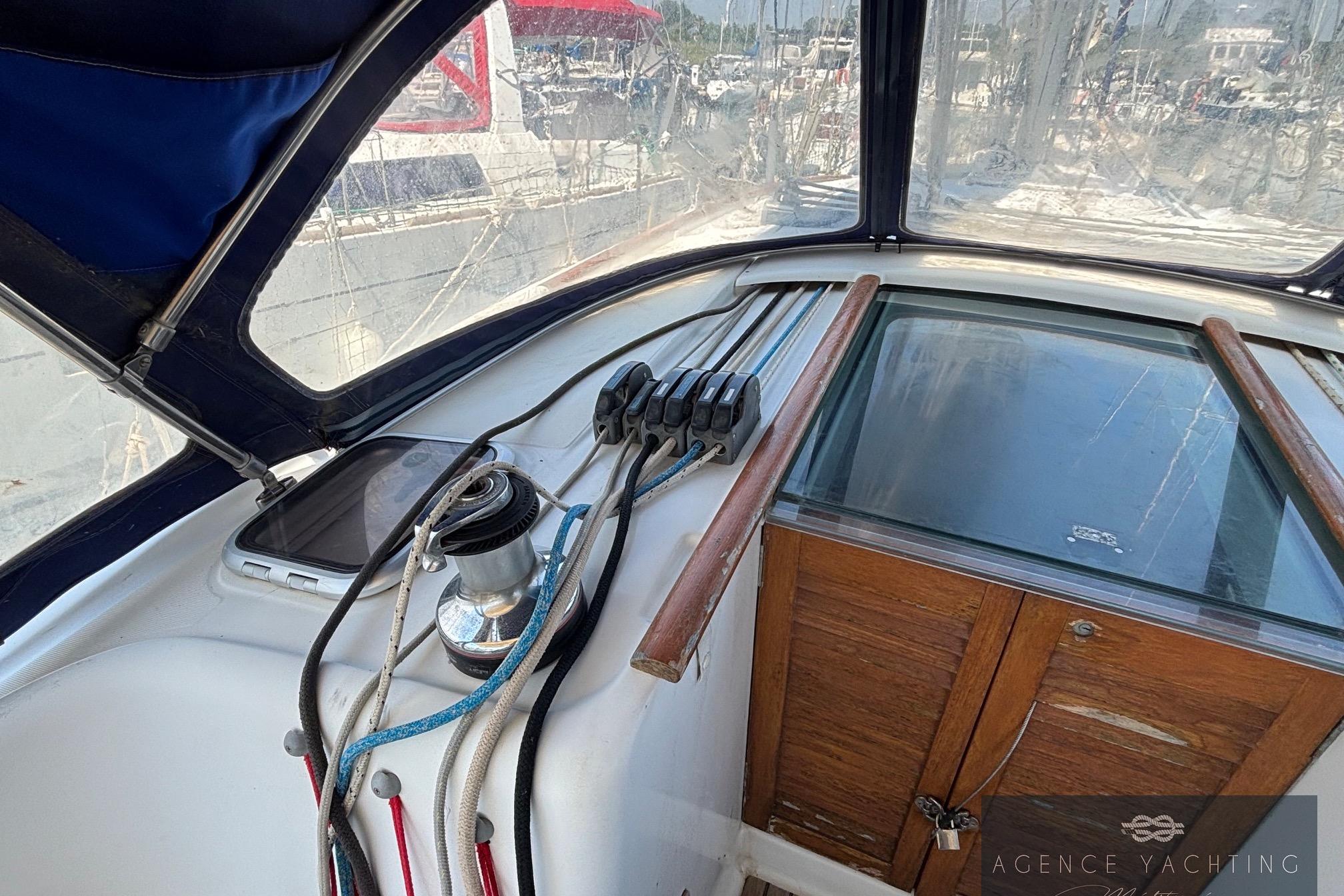 Cockpit view of a 2008 Beneteau Oceanis 40 sailboat, featuring winches and ropes.
