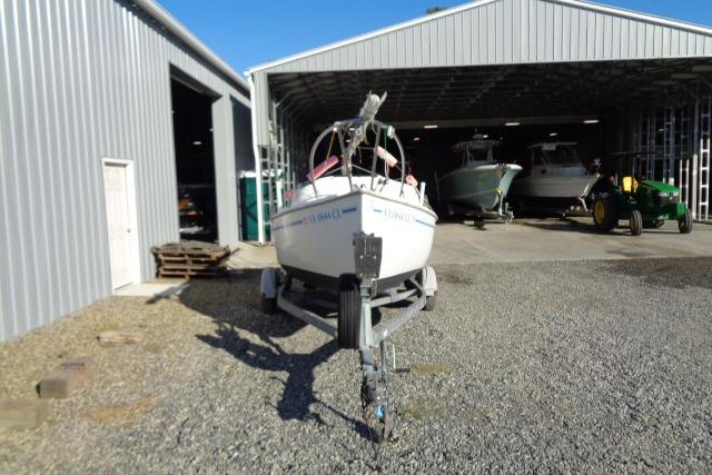 2007 Sanibel by International Marine 18 Pocket Cruiser on trailer outside metal storage building.