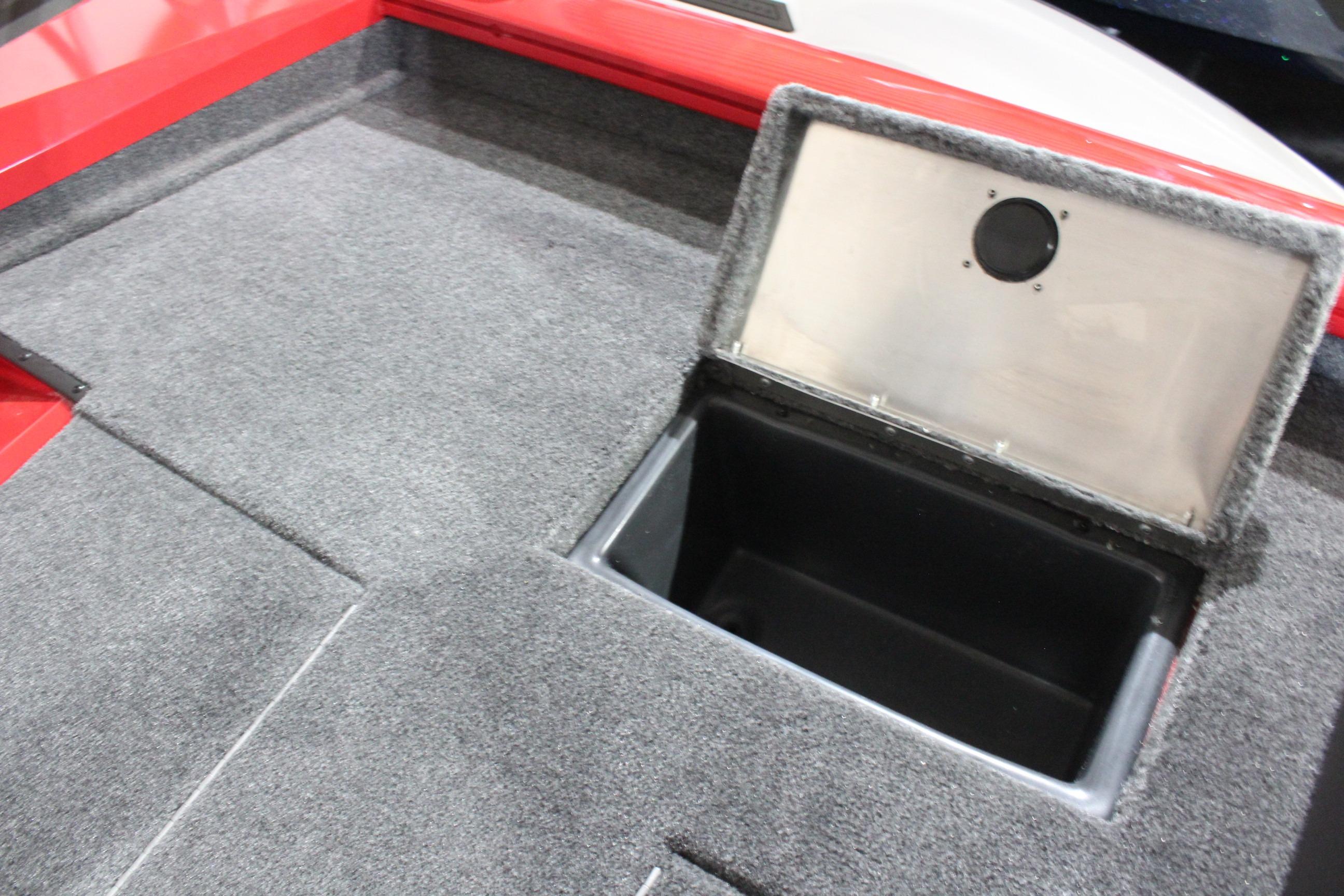 2026 Tracker Pro Team 175 boat storage compartment with open lid, featuring gray carpeted interior.