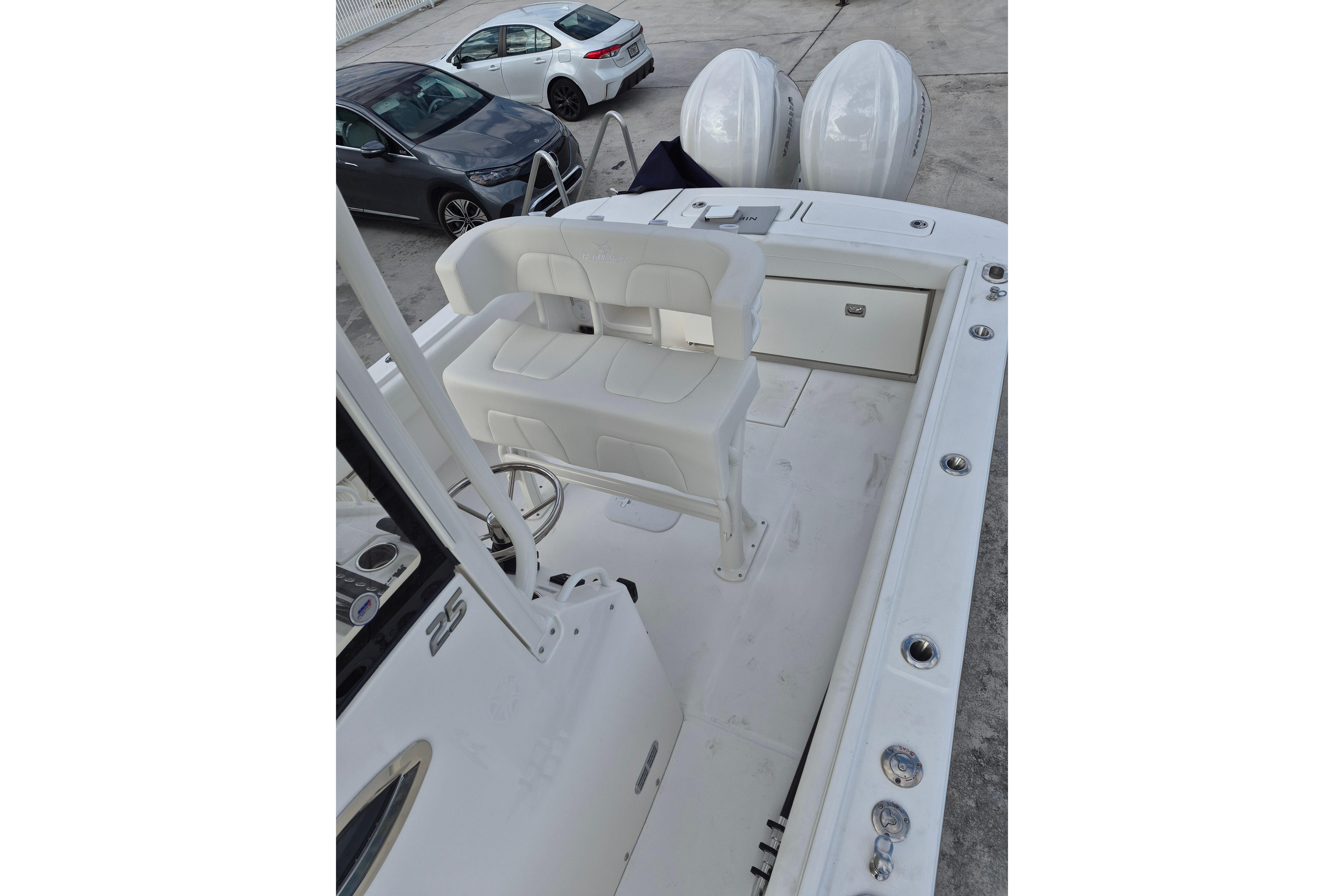 2026 Regulator 25 boat interior with seating and dual engines.