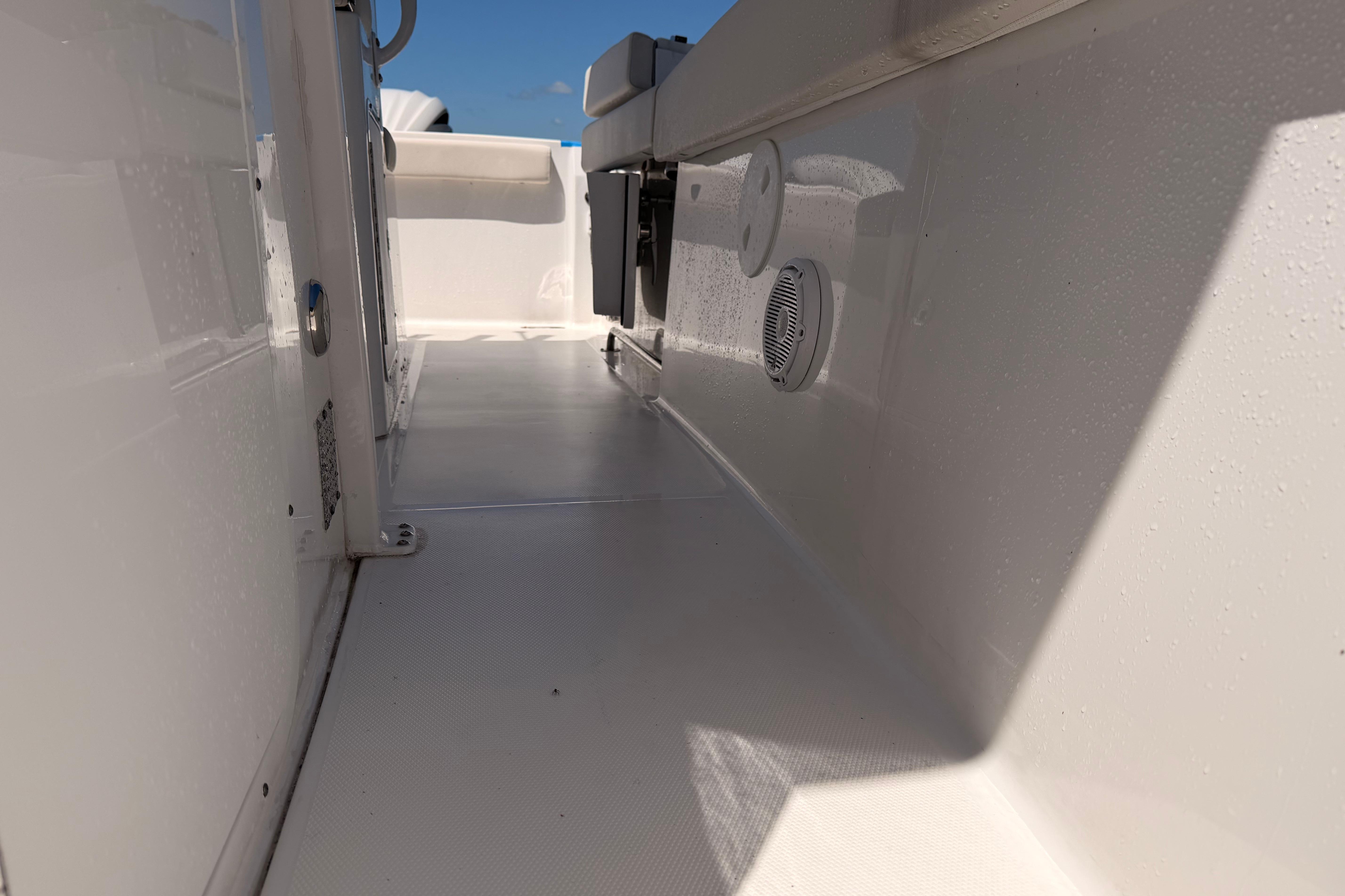 2024 Sea Hunt Gamefish 27 Coffin Box interior, showcasing sleek white deck and modern design.