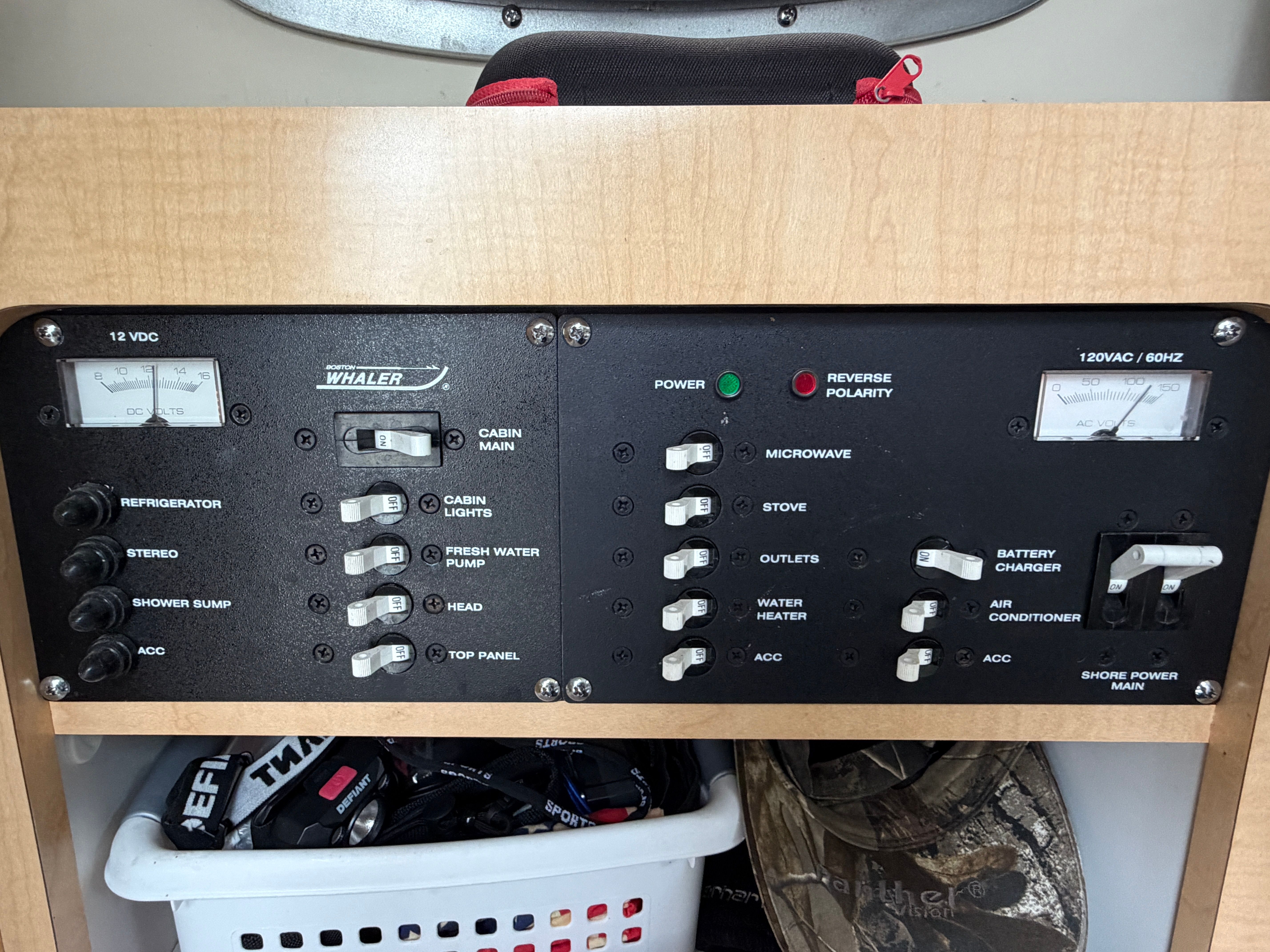 Control panel with various switches and gauges for boat functions.