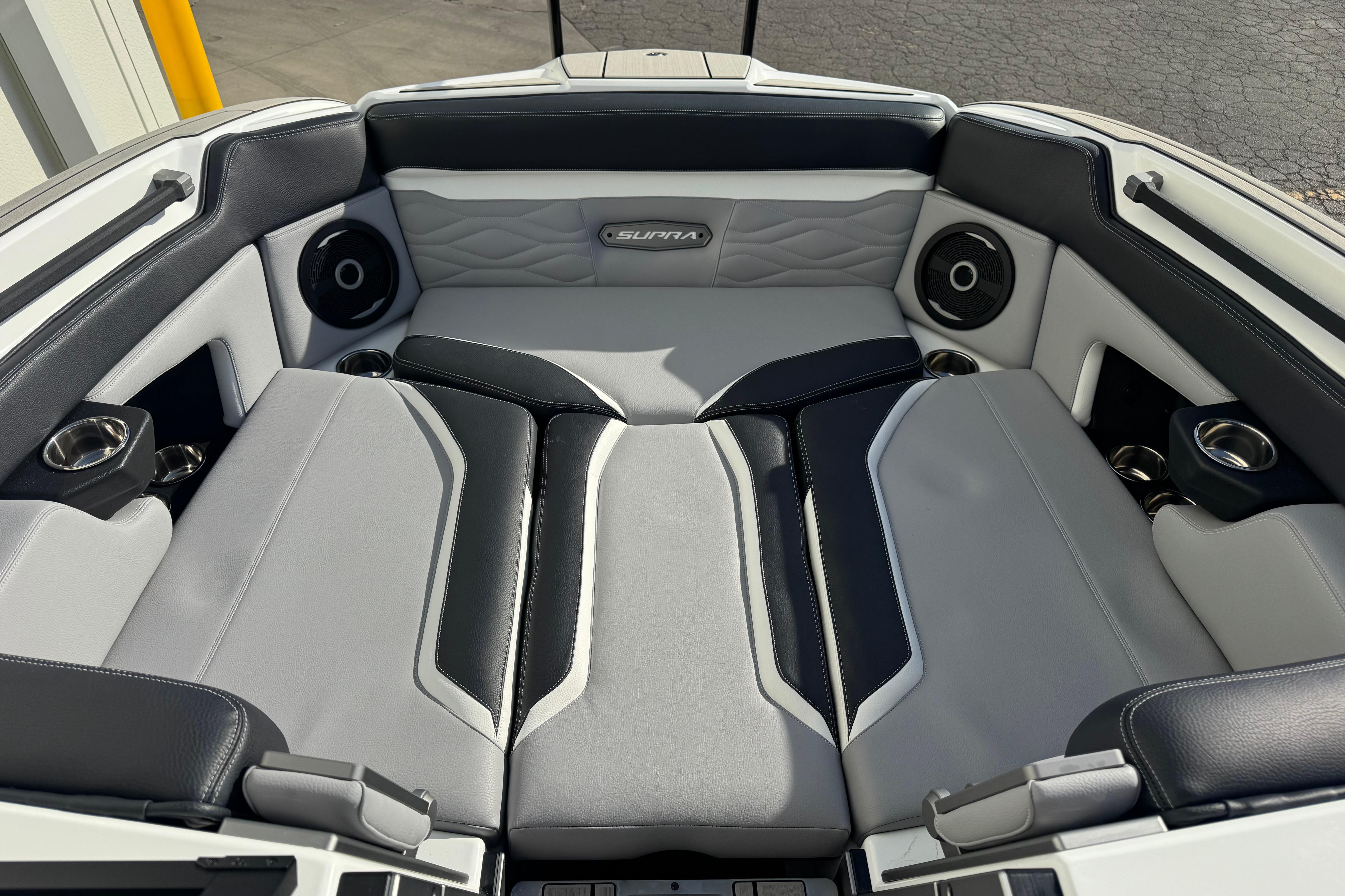 2026 Supra SE 575 boat interior with luxurious seating and integrated speakers.