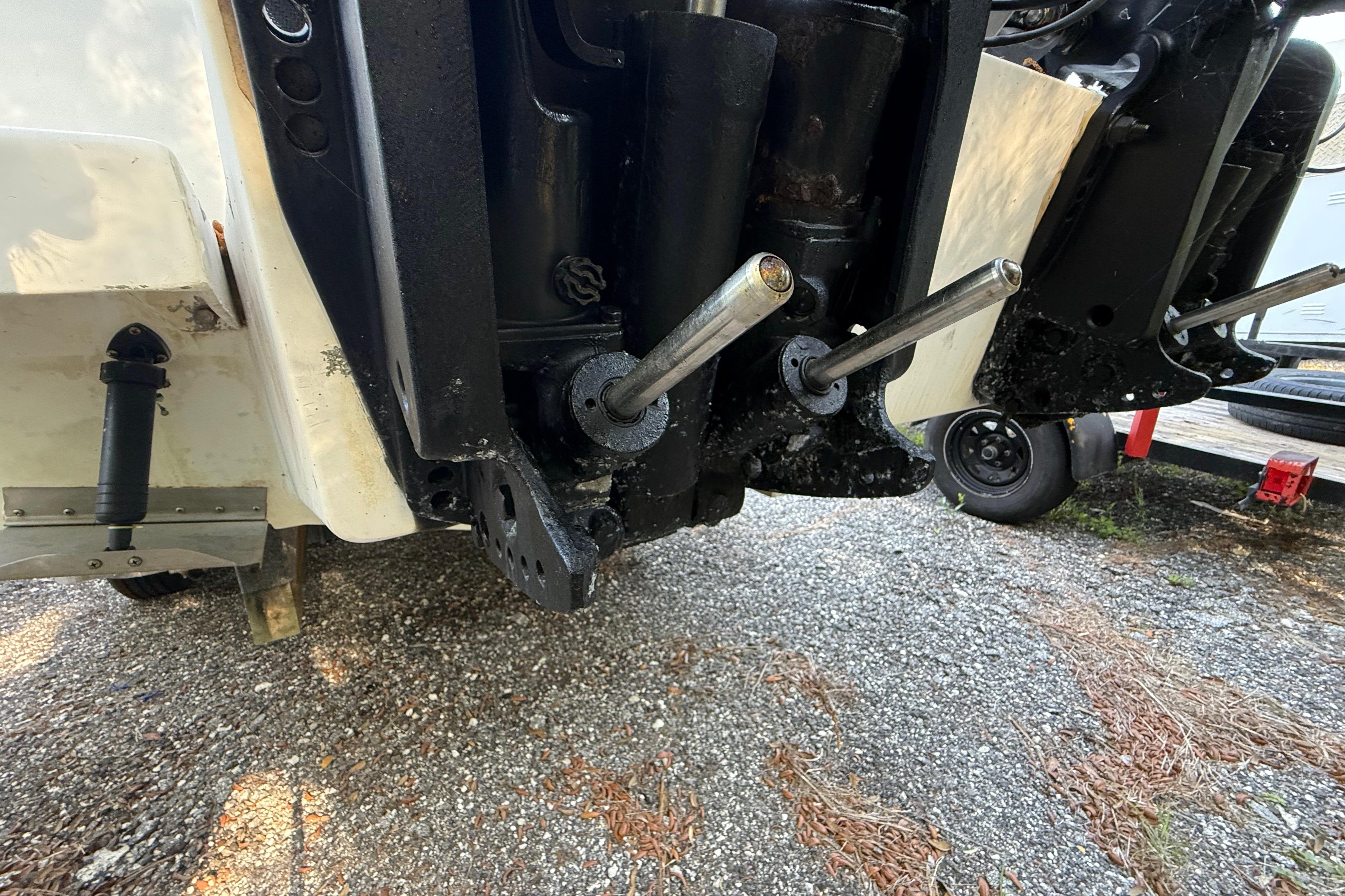 Close-up of a 2000 Sport-Craft 241 Walk Around boat's outboard motor components.