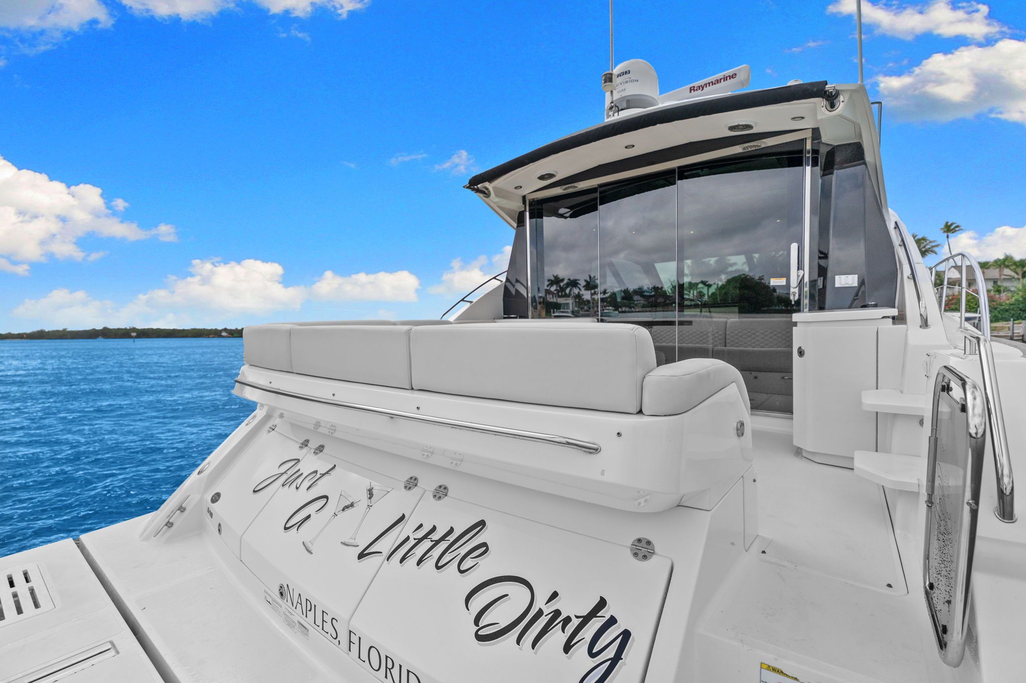 A 2017 Sea Ray Sundancer 510 on blue water with a white sky.