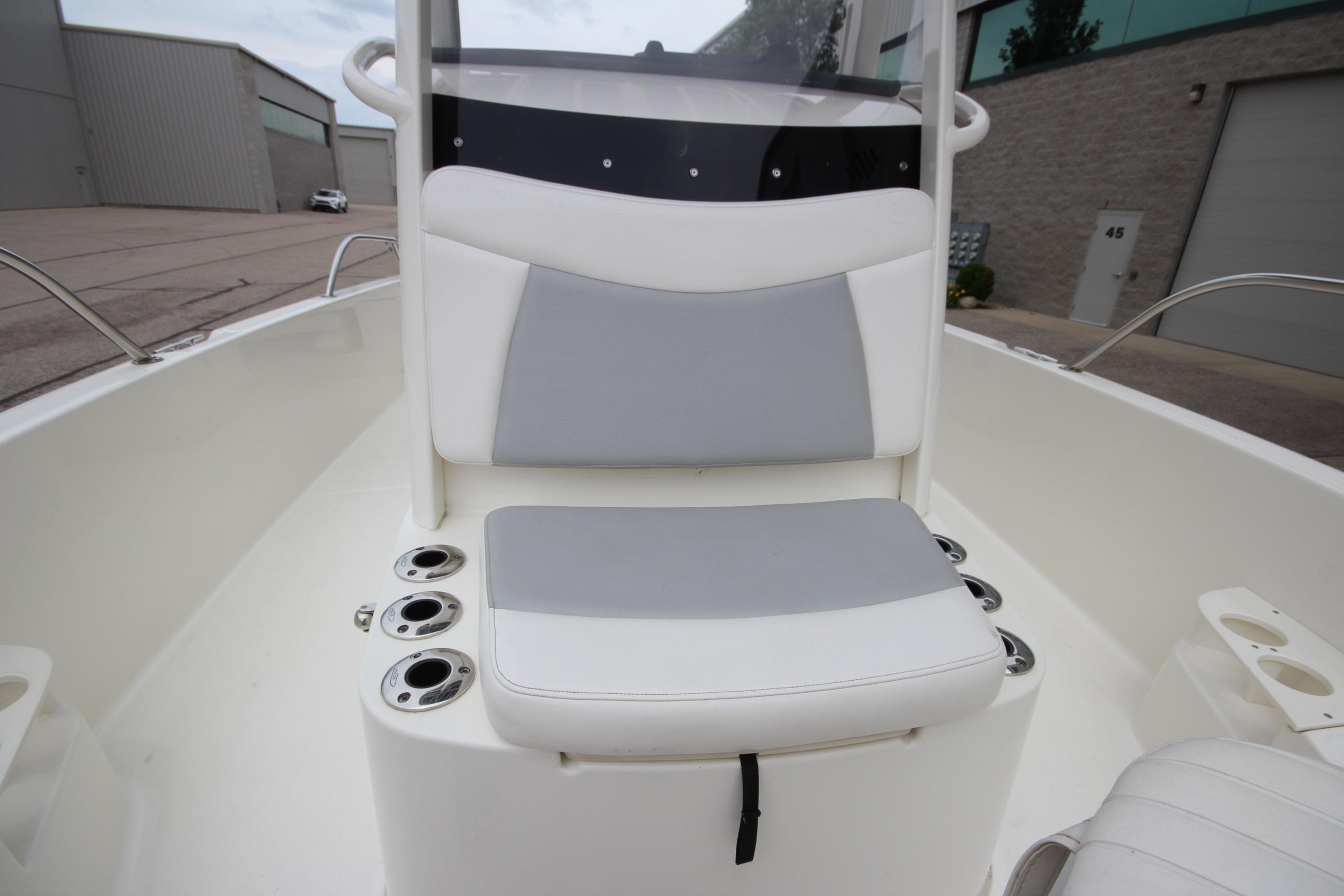 2014 Boston Whaler 210 Dauntless boat interior with cushioned seating and cup holders.