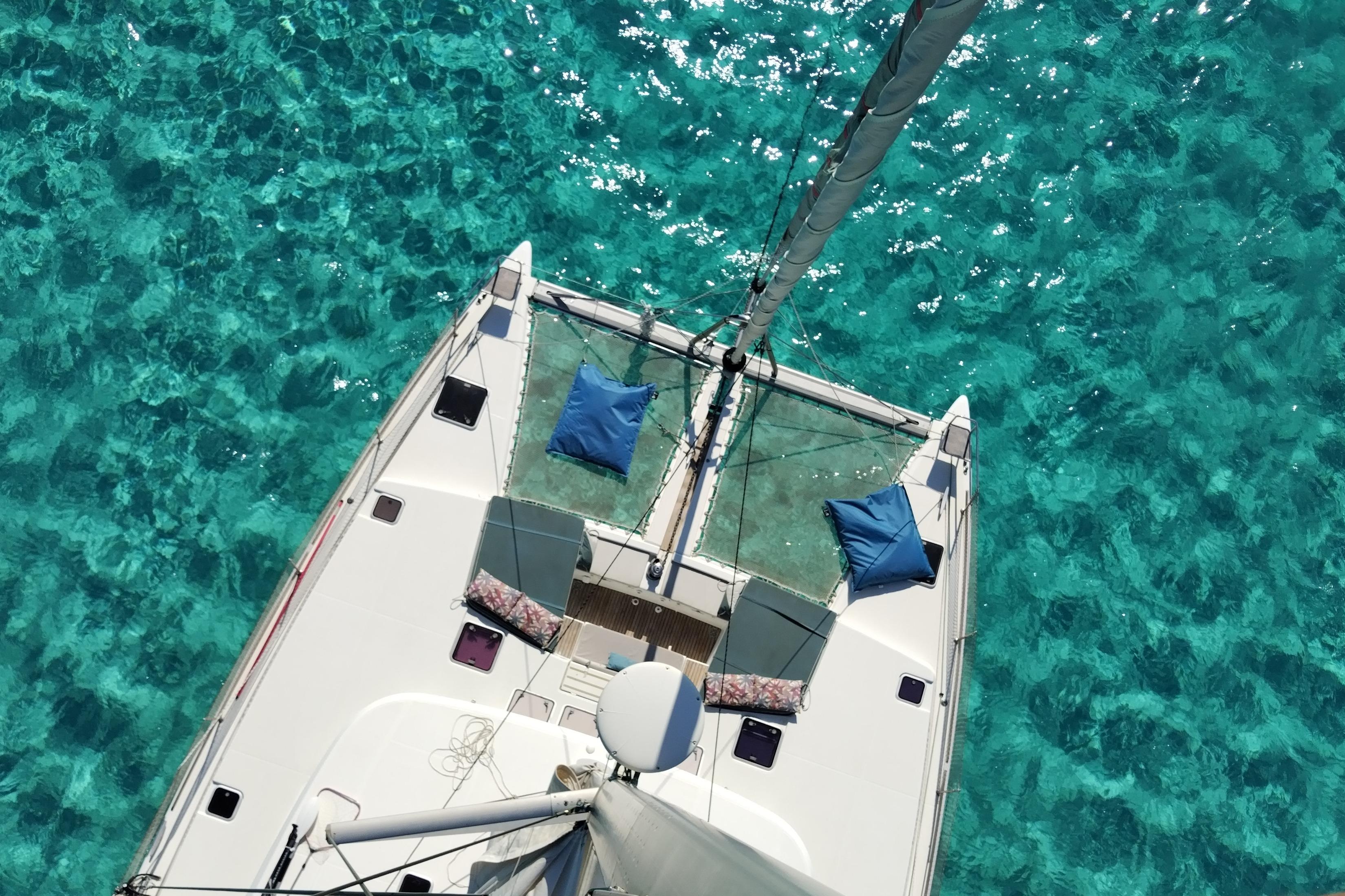 Aerial view of 2006 Lagoon 500 catamaran on clear turquoise water.