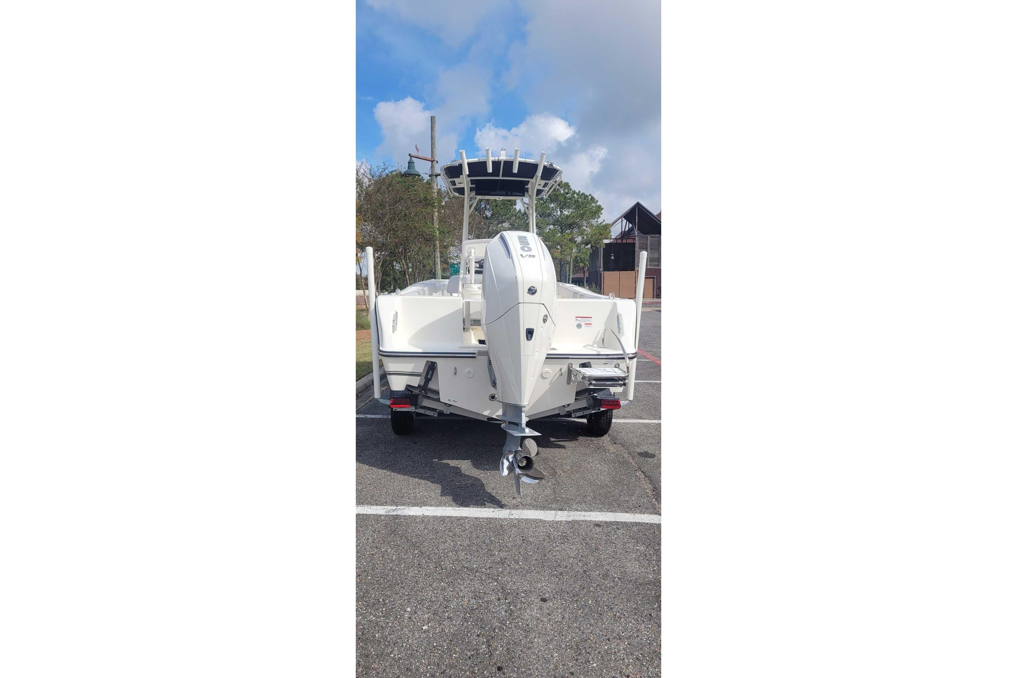2026 Mako 214 Center Console boat, rear view in parking lot.