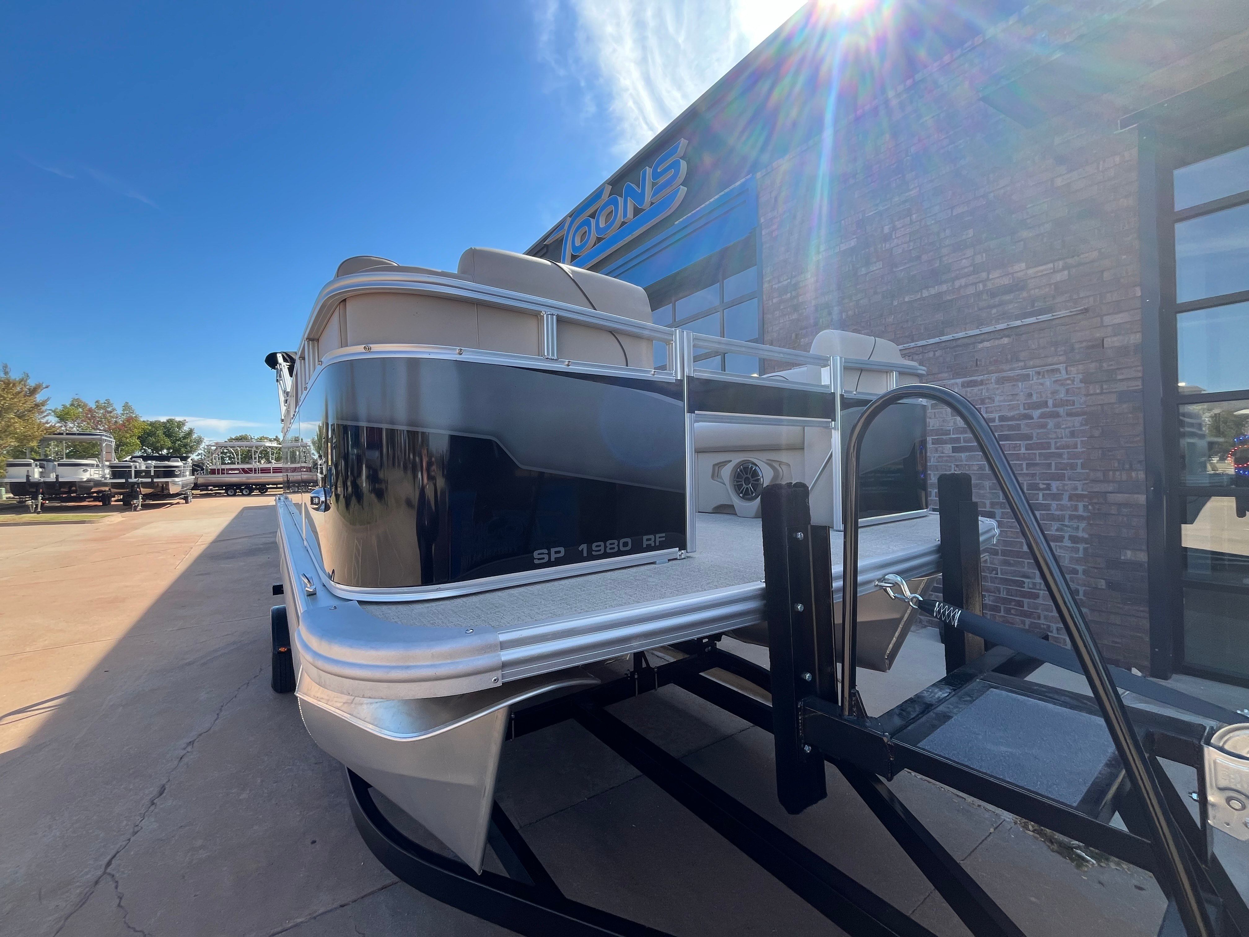 2026 Tahoe 1925 Sport Rear Fish boat on trailer in sunlight.