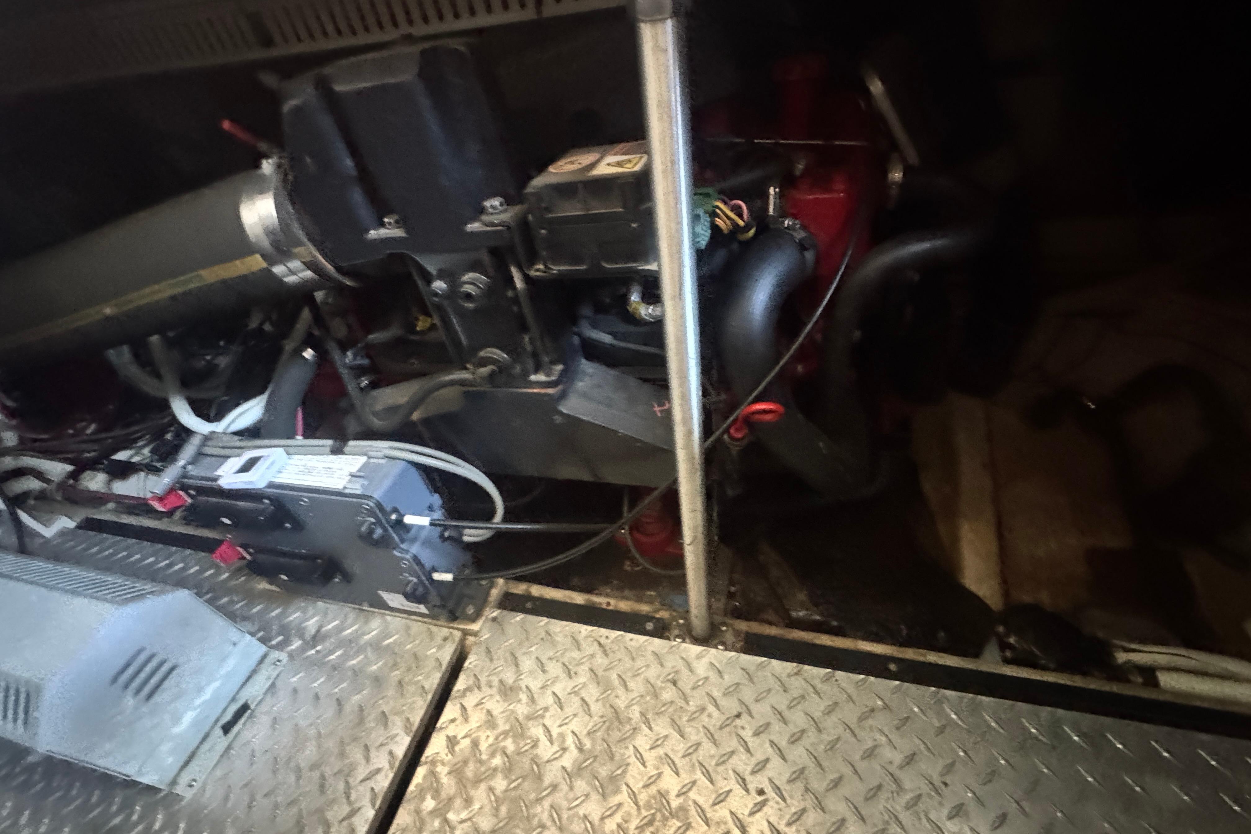 Engine compartment of a 2002 Carver 396 Motor Yacht, showcasing mechanical components.