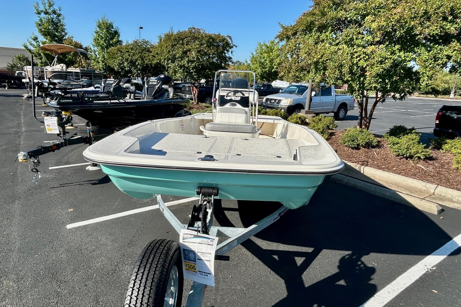 2026 Mako Pro Skiff 17 CC boat on trailer in parking lot.