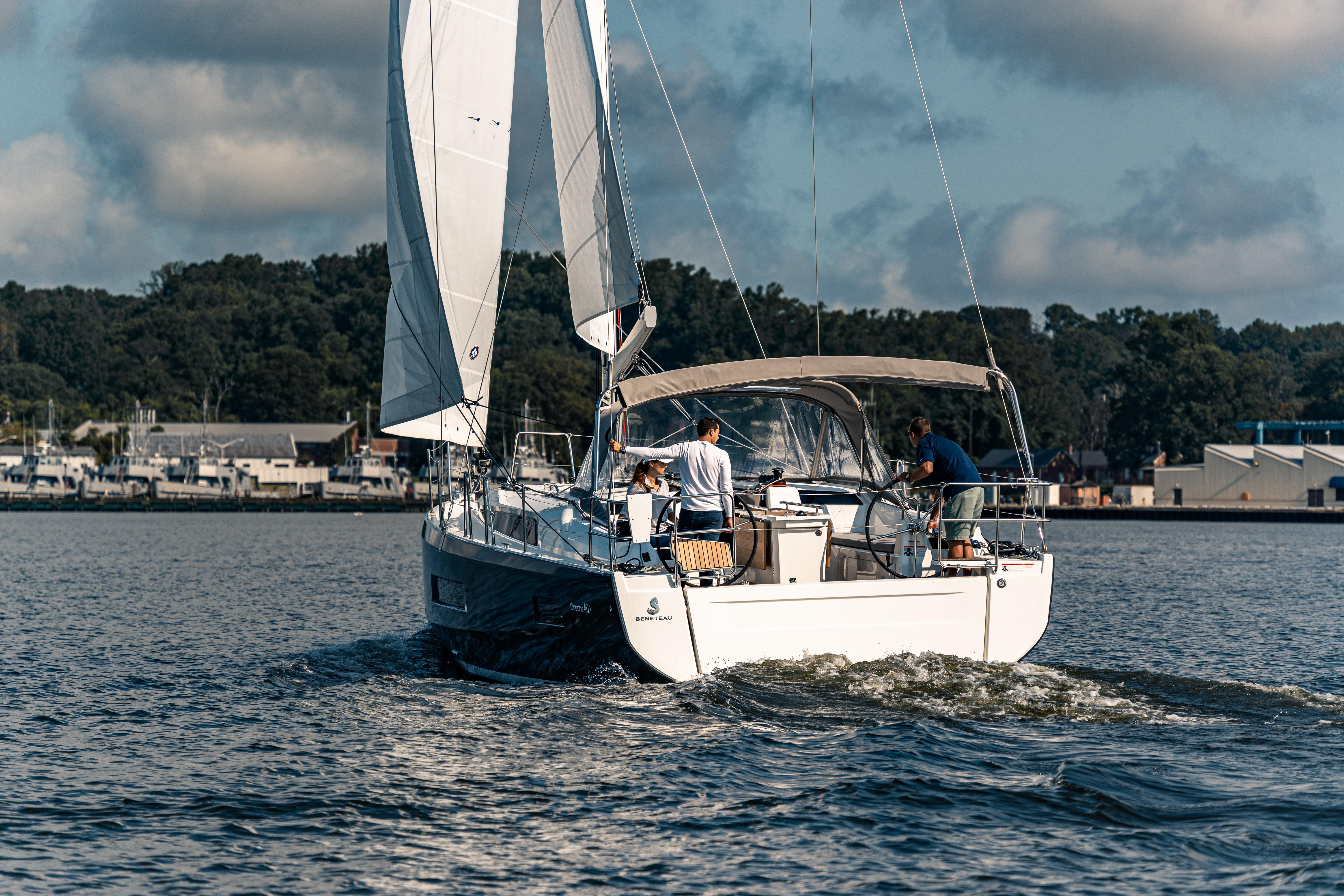 2025 Beneteau Oceanis 40.1 sailing on calm waters under a partly cloudy sky.