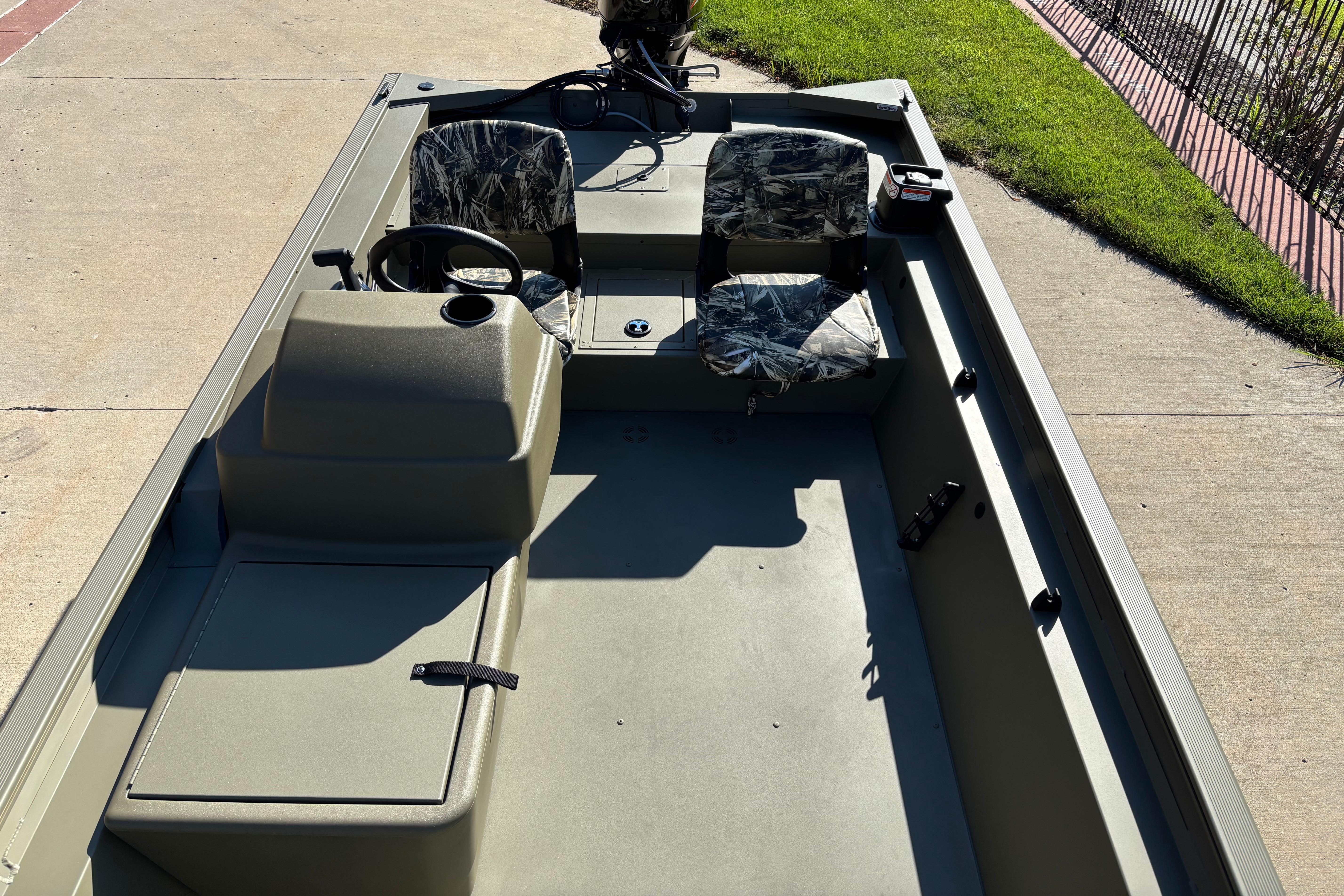 2026 Tracker Grizzly 1754 SC boat with camo seats, steering console, and spacious interior.
